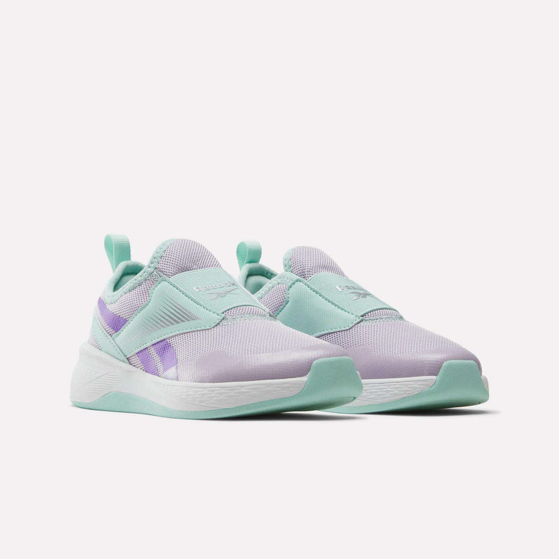 The Reebok Nano Play Slip-On Shoes for little kids feature pastel purple mesh uppers, mint green overlays and soles, and lavender side stripes—perfect girls’ training shoes shown on a white background.