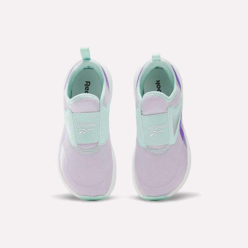 The Reebok Nano Play Slip-On Shoes for little kids feature light purple mesh uppers, mint green straps with the Reebok logo, and matching accents on the heel and sole—ideal as girls’ training shoes. Shown from above.