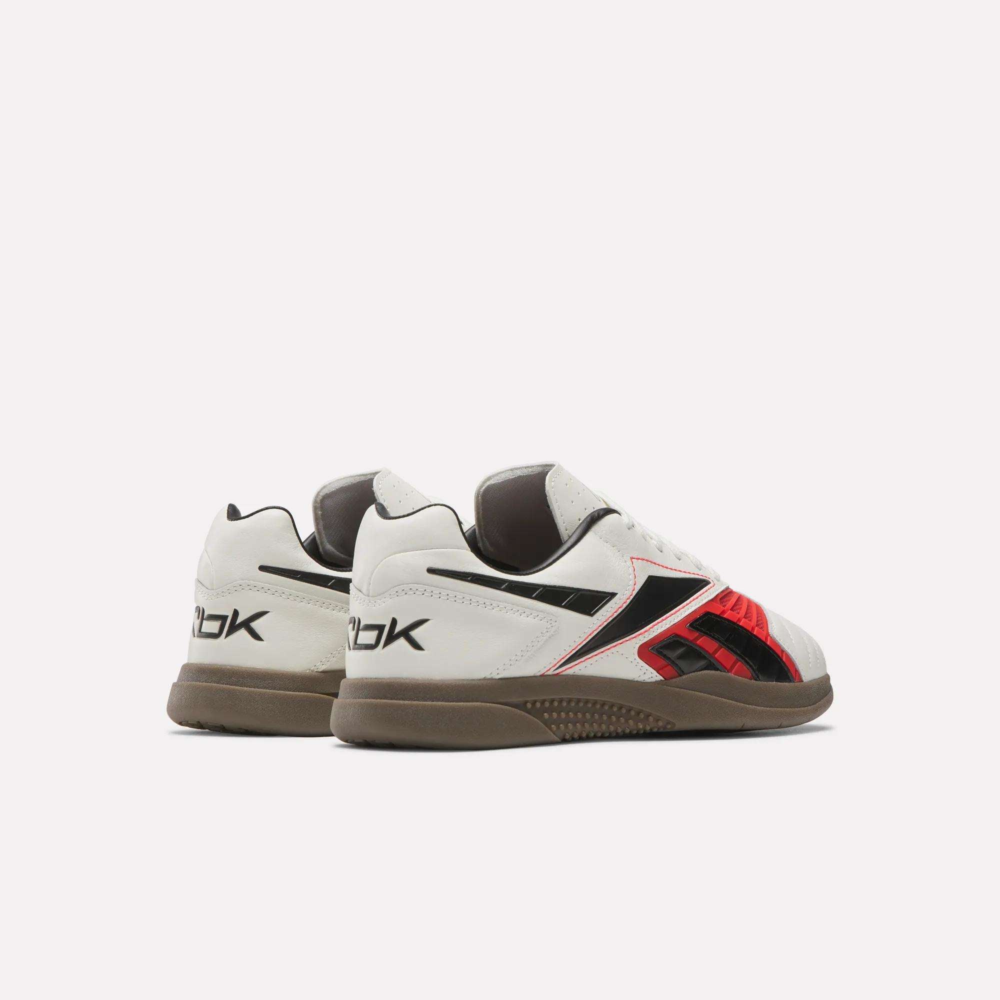 A pair of Reebok Hammer Valde Shoes featuring a white leather upper, black and red accents, brown soles, and the Reebok logo on the heel, shown on a plain white background.