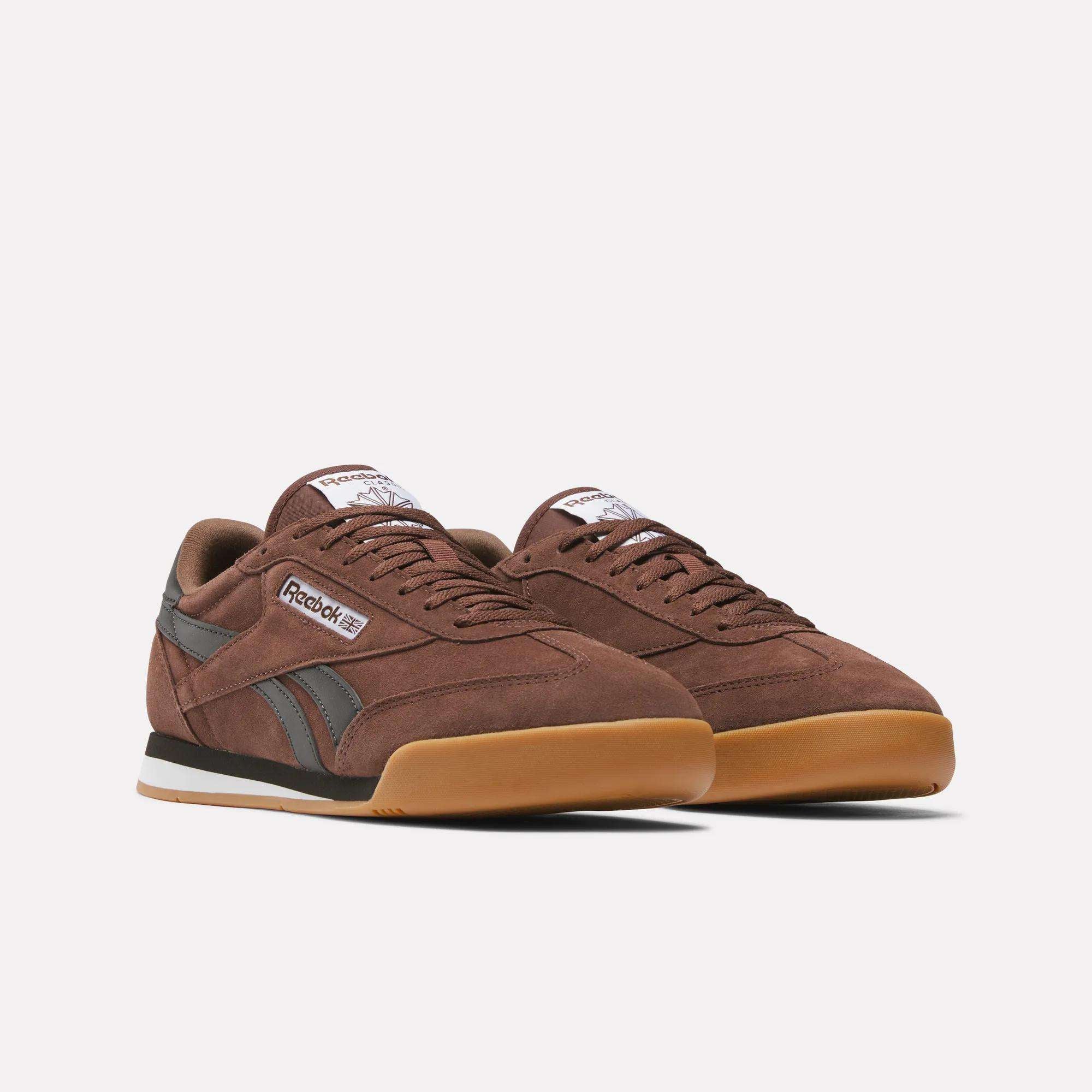 Reebok Campio XT Shoes in brown suede feature black side stripes, gum soles, white midsoles, and white Reebok branding—channeling classic '90s soccer style against a plain white background.