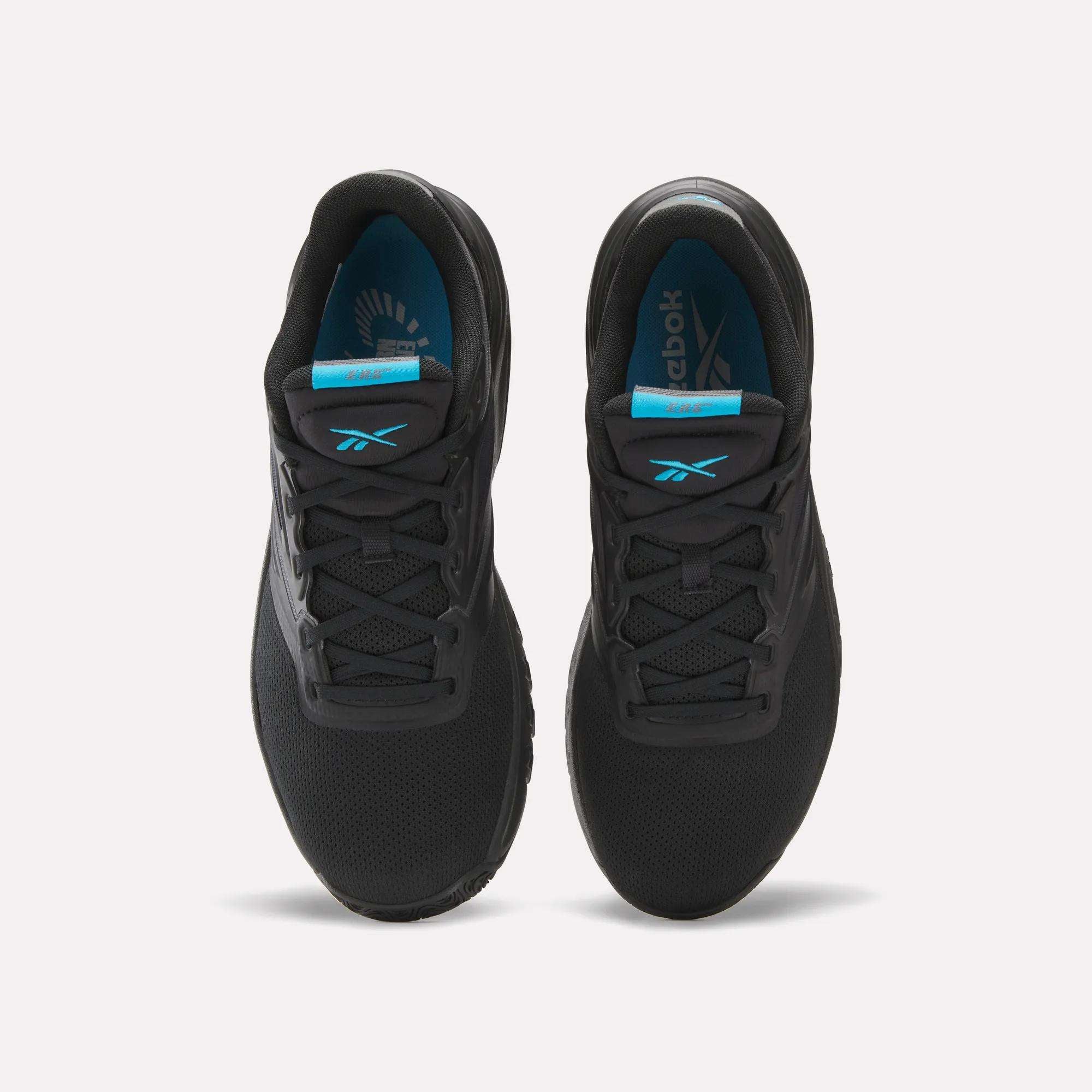 A pair of Men's ERS Training Shoes by Reebok in black, shown from above with laces, mesh texture, and blue Reebok-branded insoles—ideal for training with premium cushioning for comfort.