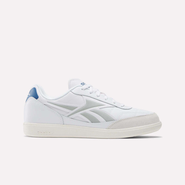 The Reebok Finale Shoes feature white uppers, light gray side stripes, a blue heel accent, white laces, and beige soles for a retro sport look, shown against a simple light background.
