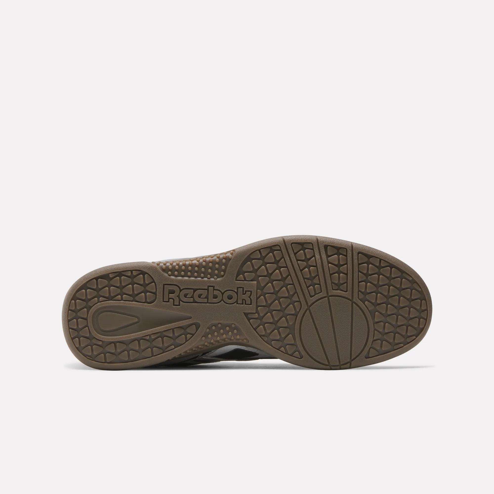 The outsole of the Reebok Hammer Street Shoes is shown from below, featuring a textured tread with circular and triangular patterns and the embossed Reebok logo near the heel—ideal for fans of soccer-inspired footwear.