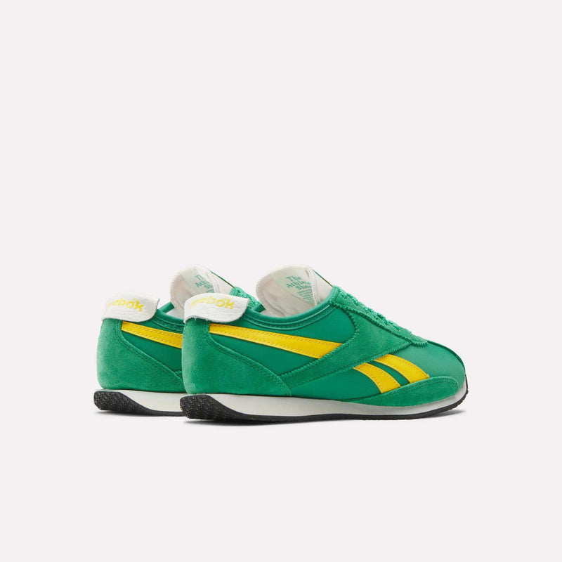 A pair of Reebok R400 Shoes in green with yellow stripes and black soles is displayed on a white background, viewed from a rear diagonal angle.