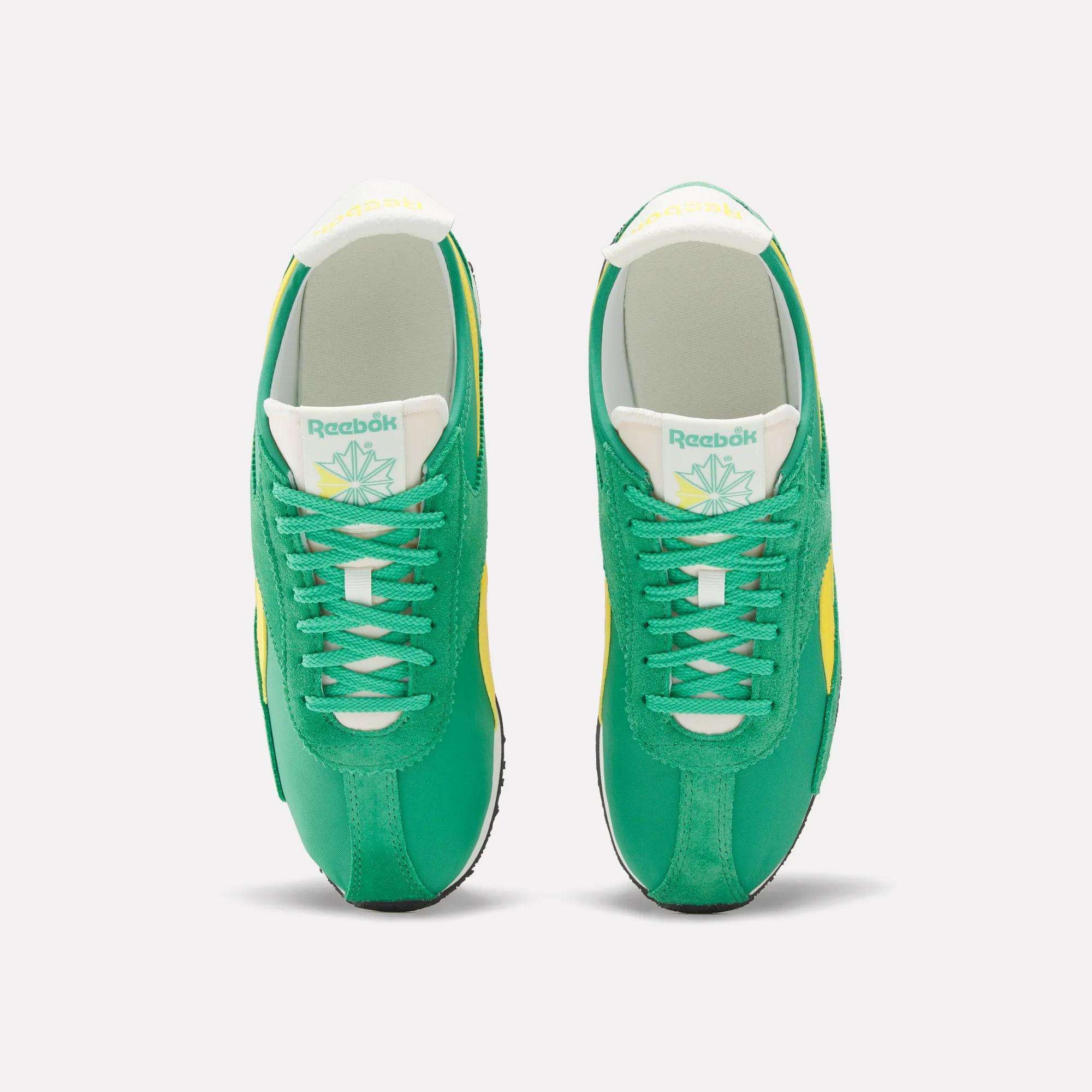 A pair of Reebok R400 Shoes in green, featuring white laces, yellow accents, a white tongue with the Reebok logo and a leaf graphic, crafted from lightweight EVA, shown from above on a plain white background.