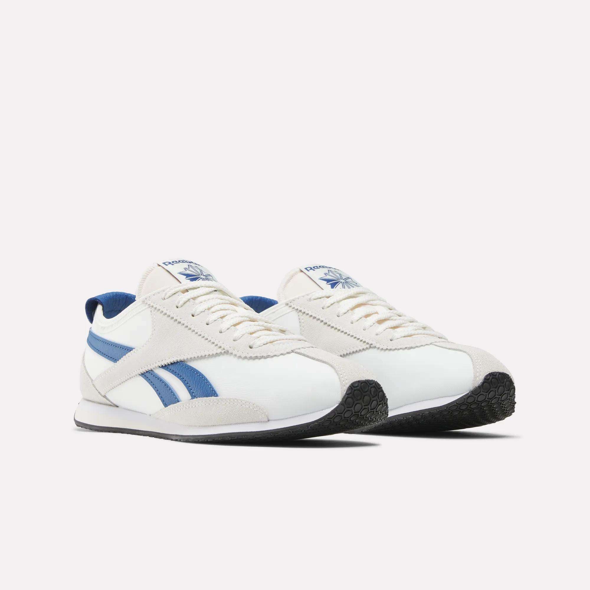 A pair of Reebok R400 Shoes in white with blue side stripes, white laces, and black textured soles are displayed side by side on a plain white background.