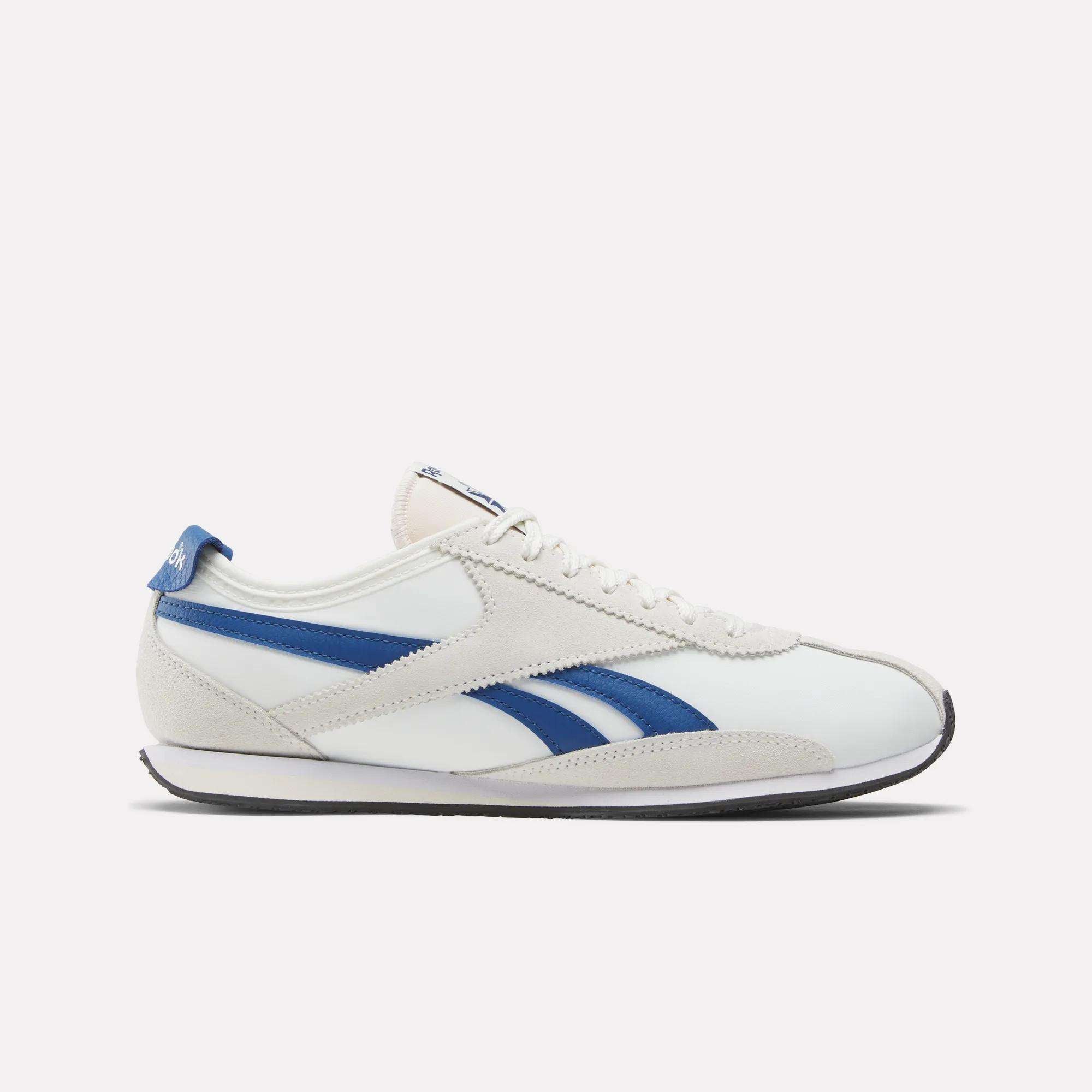 The Reebok R400 Shoes are white with beige suede accents, blue logo stripes, a blue heel tab, and a black sole. The low-profile sneaker is shown in profile against a plain, light background.