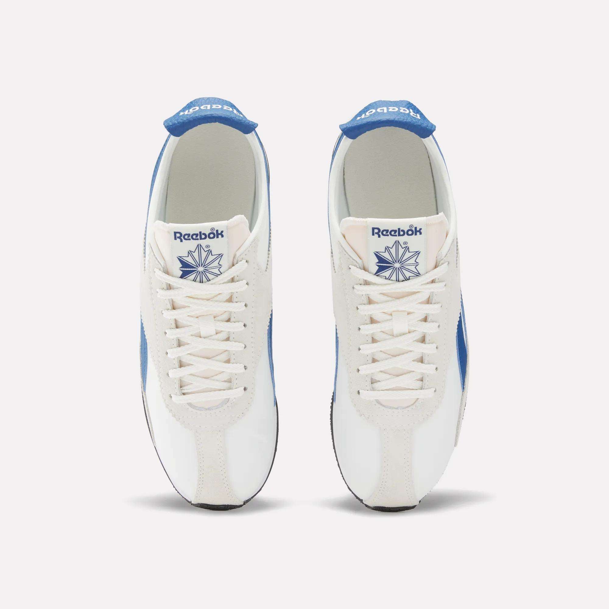 A pair of Reebok R400 Shoes in white, featuring blue accents and the logo, shown from above to display the tops and laces.