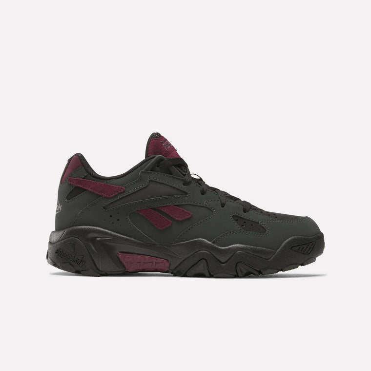 The Reebok Preseason 94 Low Retro Basketball Shoes feature a black and dark green design with maroon accents on the tongue, heel, and logo. A chunky black sole with textured details makes these sneakers stand out on a light background.