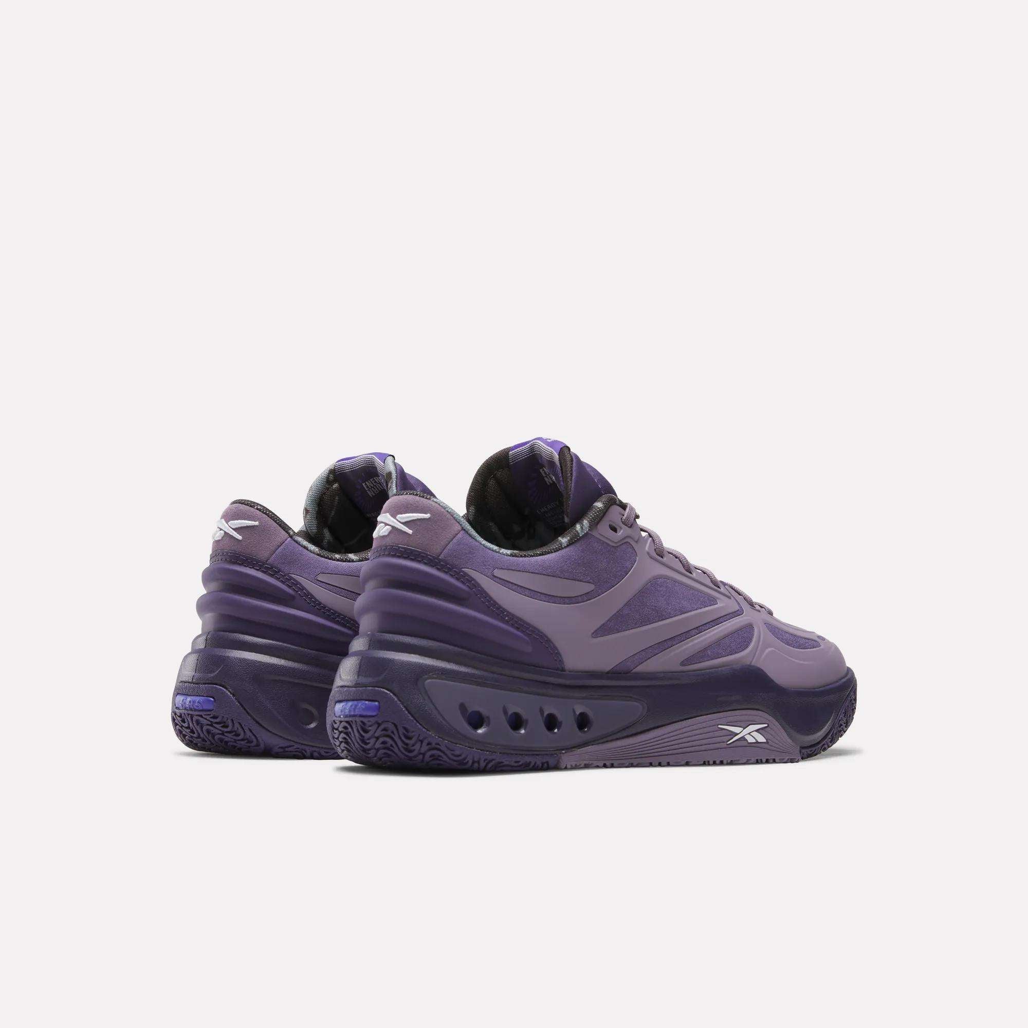 A pair of Reebok Engine A Basketball Shoes in purple with chunky soles and wavy detailing, featuring SuperFloat foam for comfort, shown from the back and side on a plain white background.