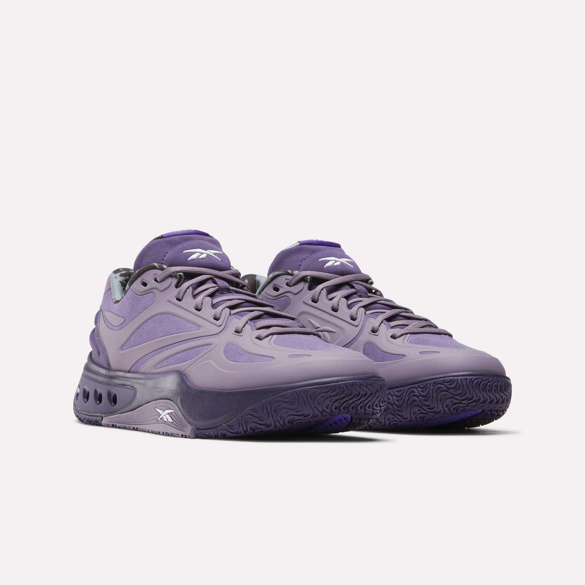 A pair of Reebok Engine A Basketball Shoes in purple, featuring a chunky sole, wavy design details, and SuperFloat foam for comfort, displayed against a plain white background.
