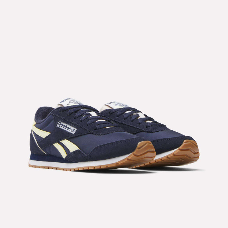 The Reebok Women's Classic AZ Shoes in navy blue with cream accents, white laces, and gum rubber soles blend vintage style with modern comfort, shown against a plain white background.