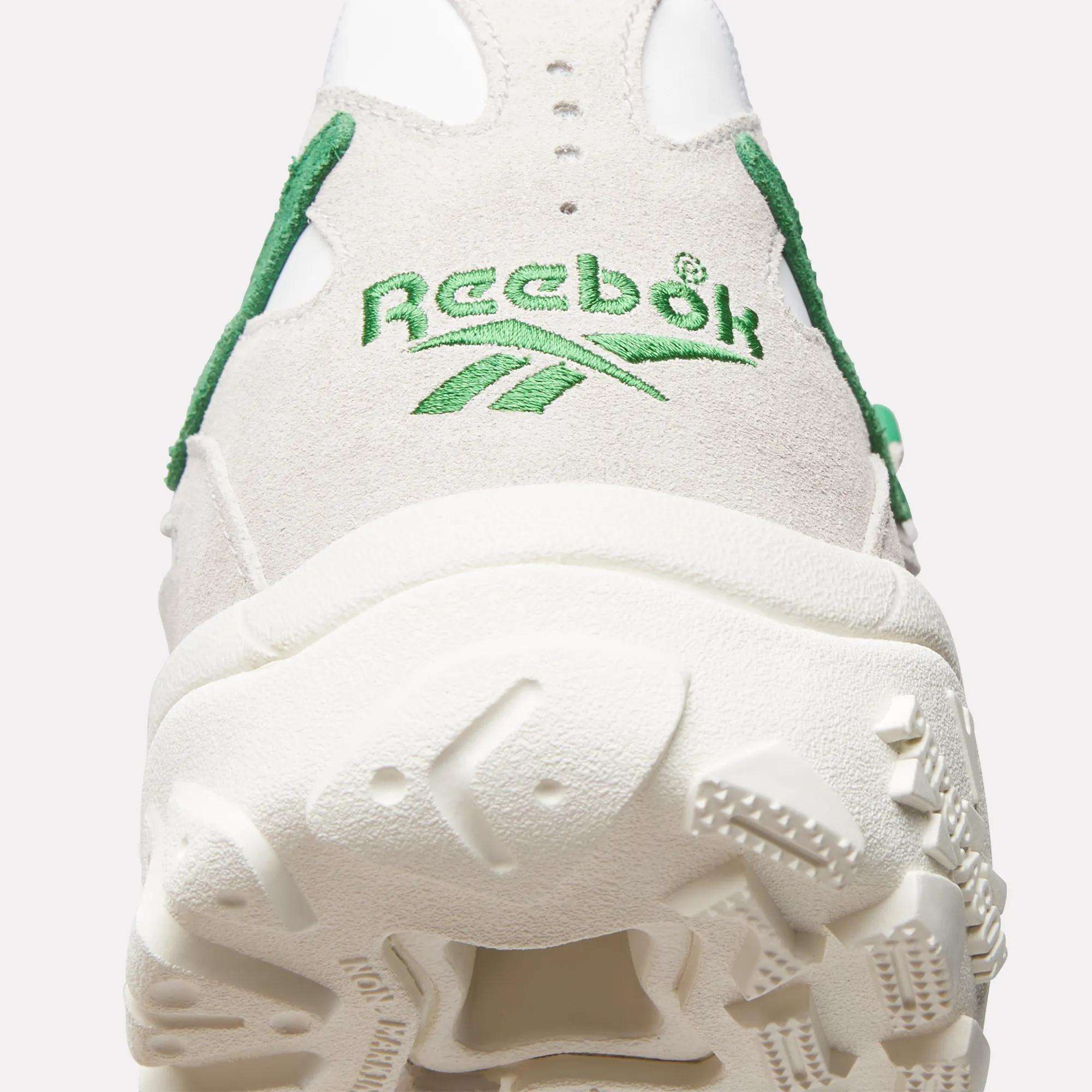 Close-up of the heel on the Reebok Preseason 94 Low Retro Basketball Shoes in white and beige, inspired by '90s athletic archives, featuring green stitching, the Reebok logo, and a textured sole.