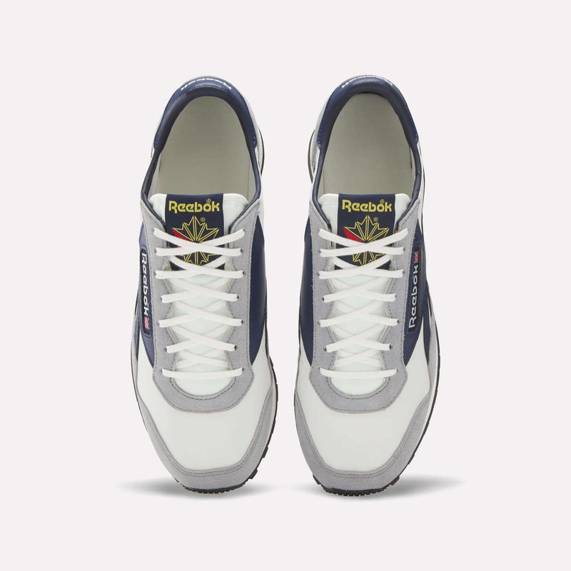 A pair of Reebok Aztec II Shoes seen from above, with white laces, navy and gray panels, and gold Reebok logos on the tongues—retro running sneakers inspired by 1980s marathon style.
