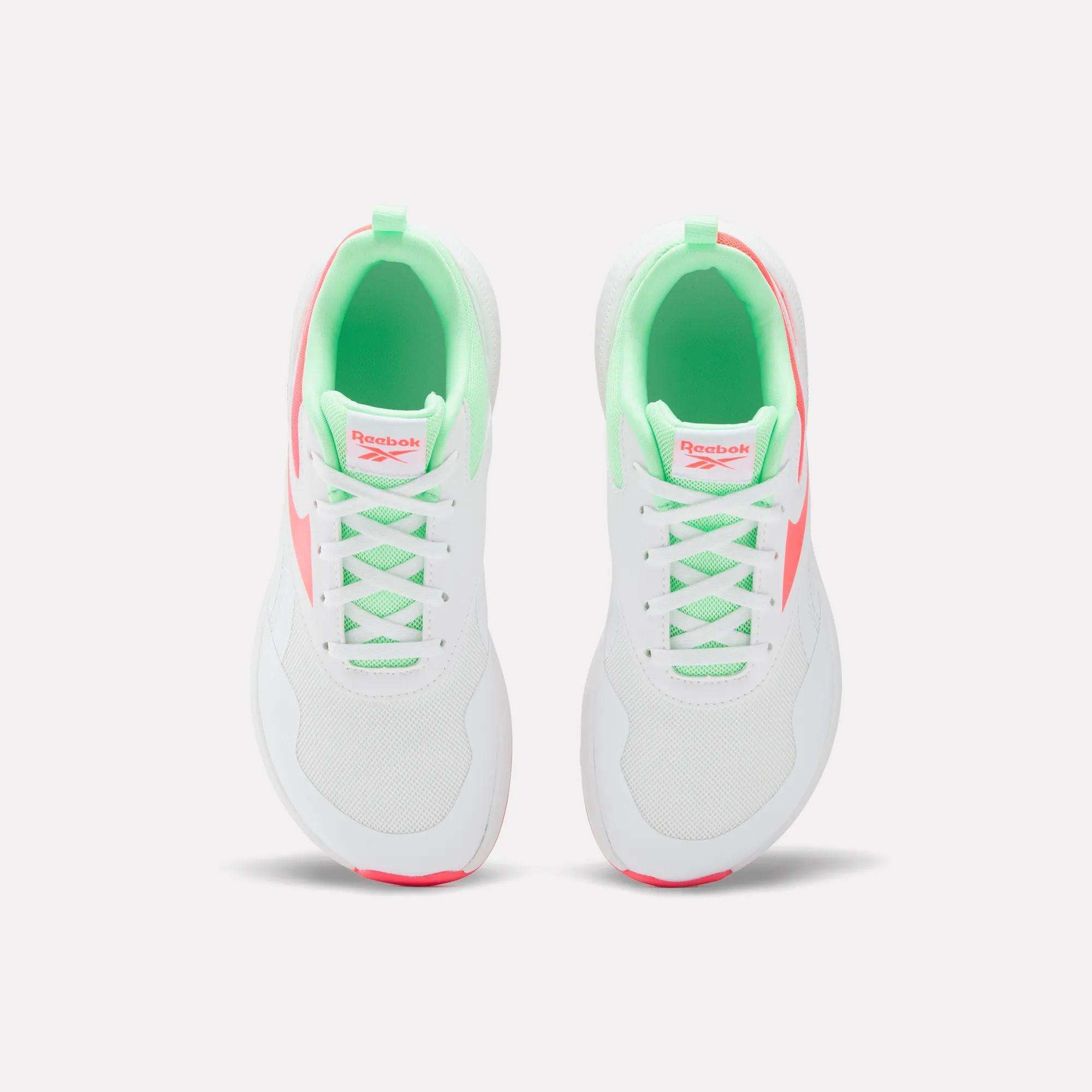 Top view of Reebok Nano Play Shoes for little kids, featuring a neon green inner lining and pink logo on the tongue with pink accents. Designed for kids’ comfort, these athletic shoes are shown on a plain white background.
