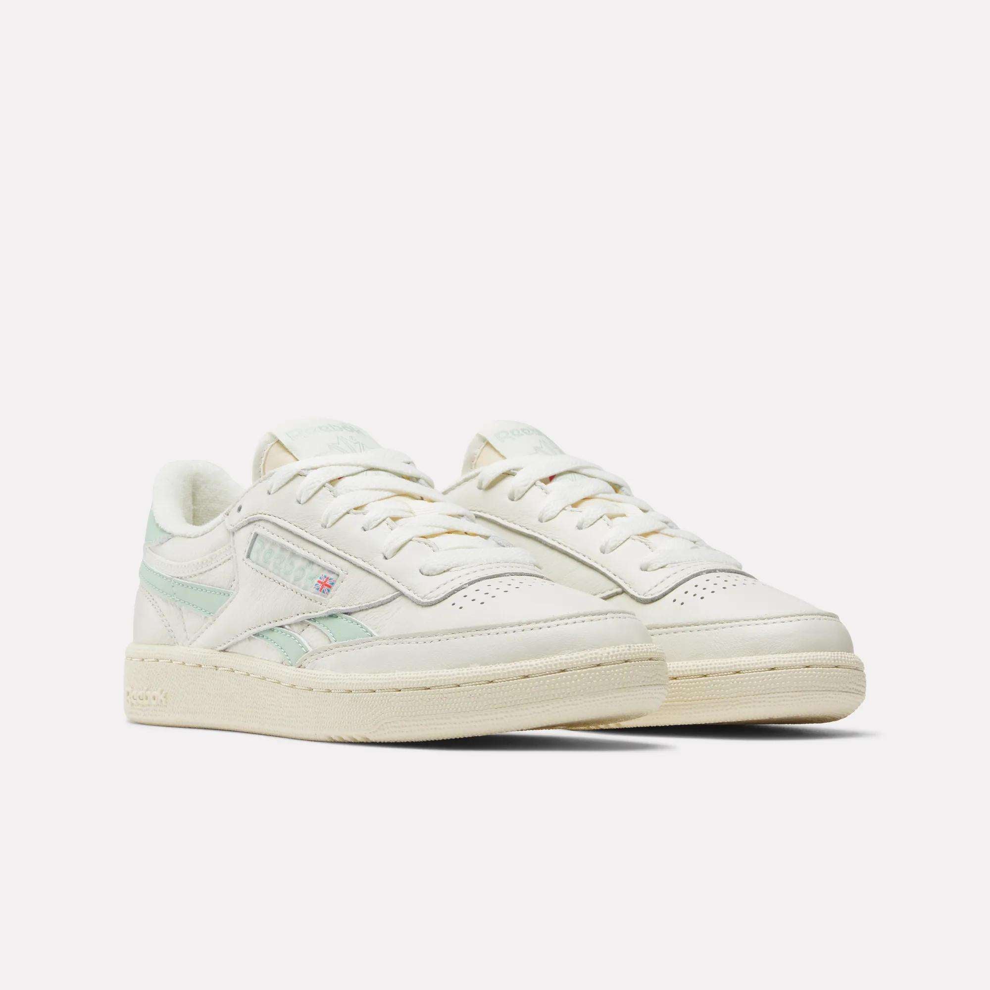 The Reebok Women's Club C Revenge Vintage Shoes feature off-white uppers, light green accents, cream soles, and the iconic side logo—a perfect choice for women seeking timeless style. Displayed on a white background.