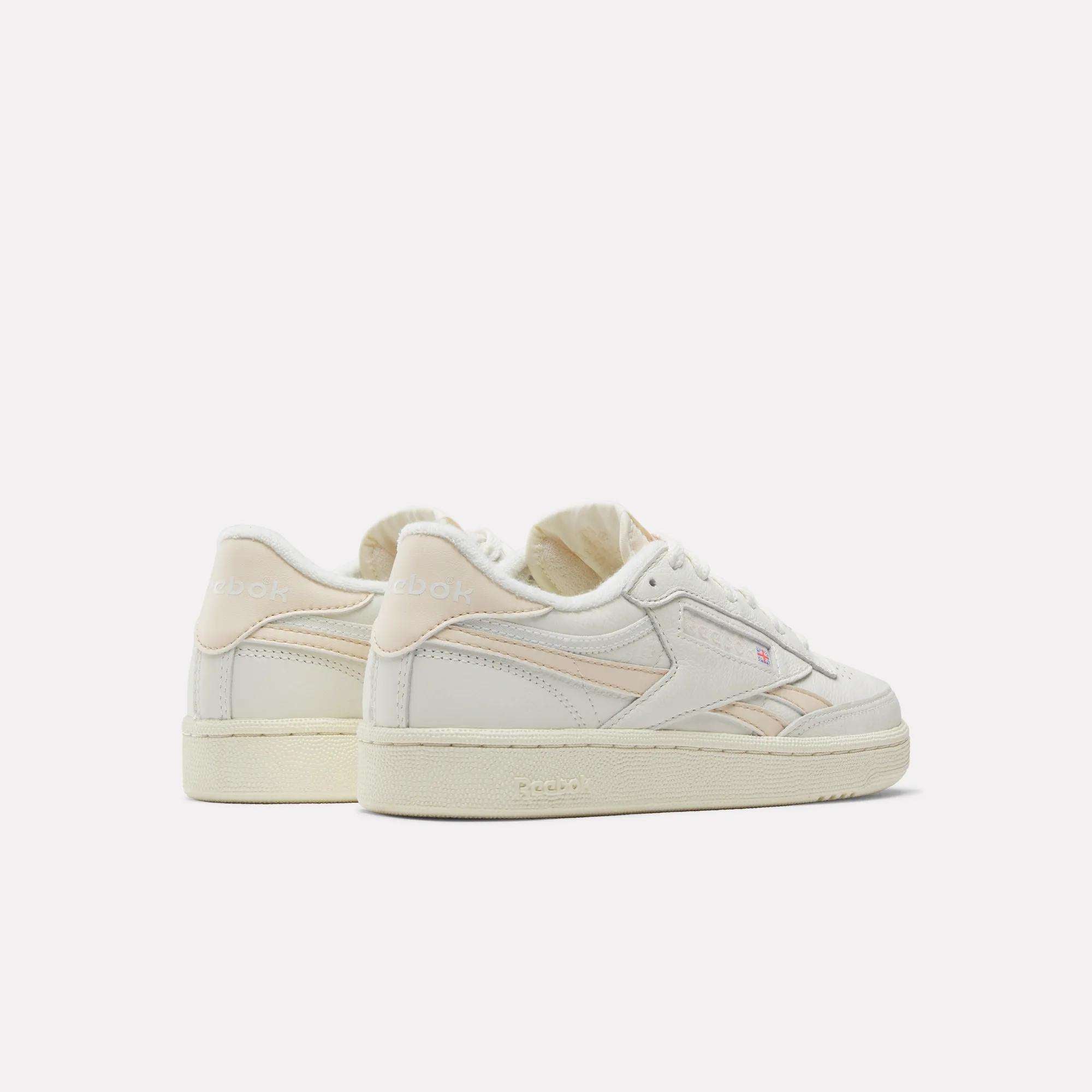 Displayed against a white background, the Reebok Women's Club C Revenge Vintage Shoes feature off-white with light beige accents. Side and back views highlight their timeless style—an essential addition to any women's shoe collection.