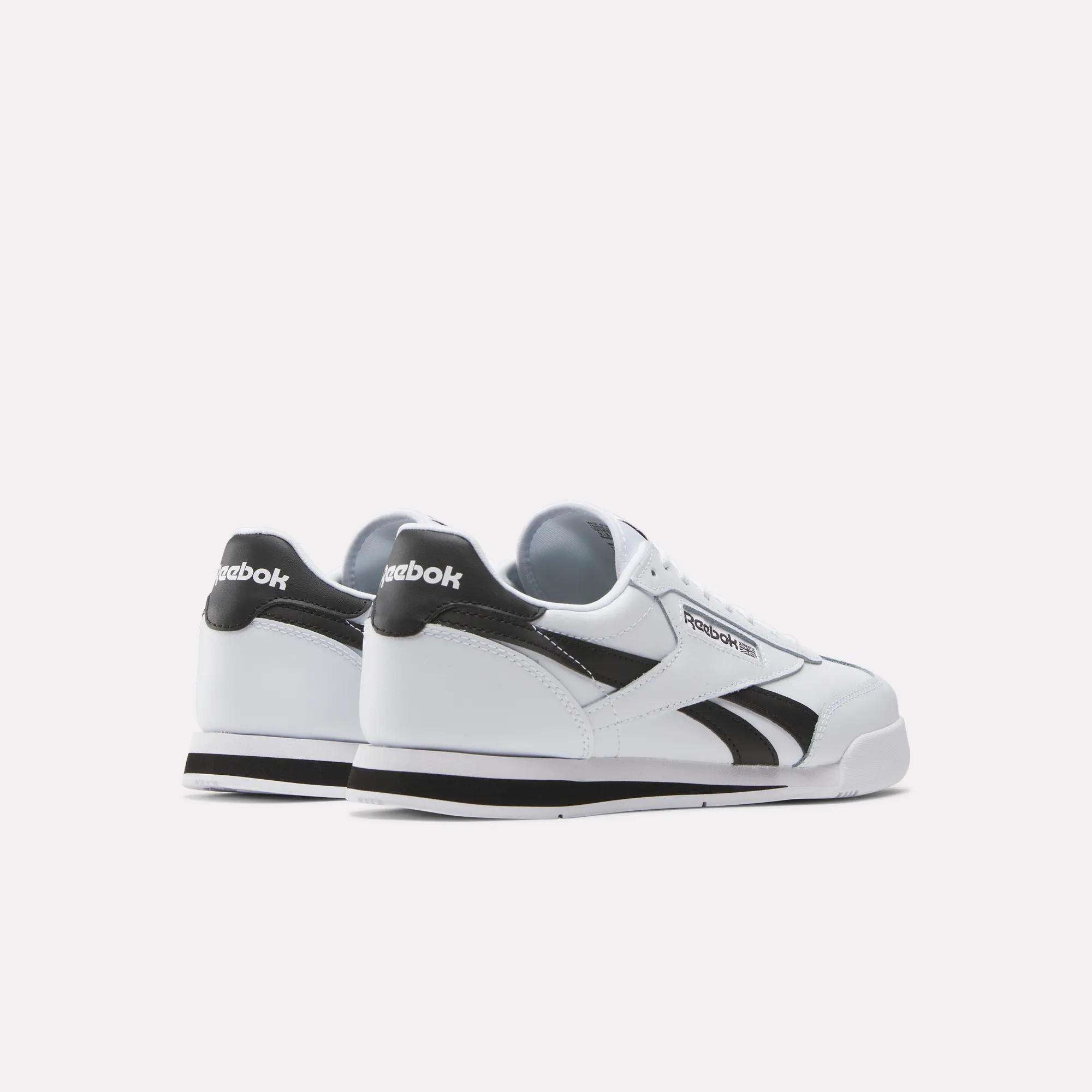 A pair of Reebok Campio XT Shoes in white with black accents and the Reebok logo on the side and heel, displayed from back and side views against a plain white background.