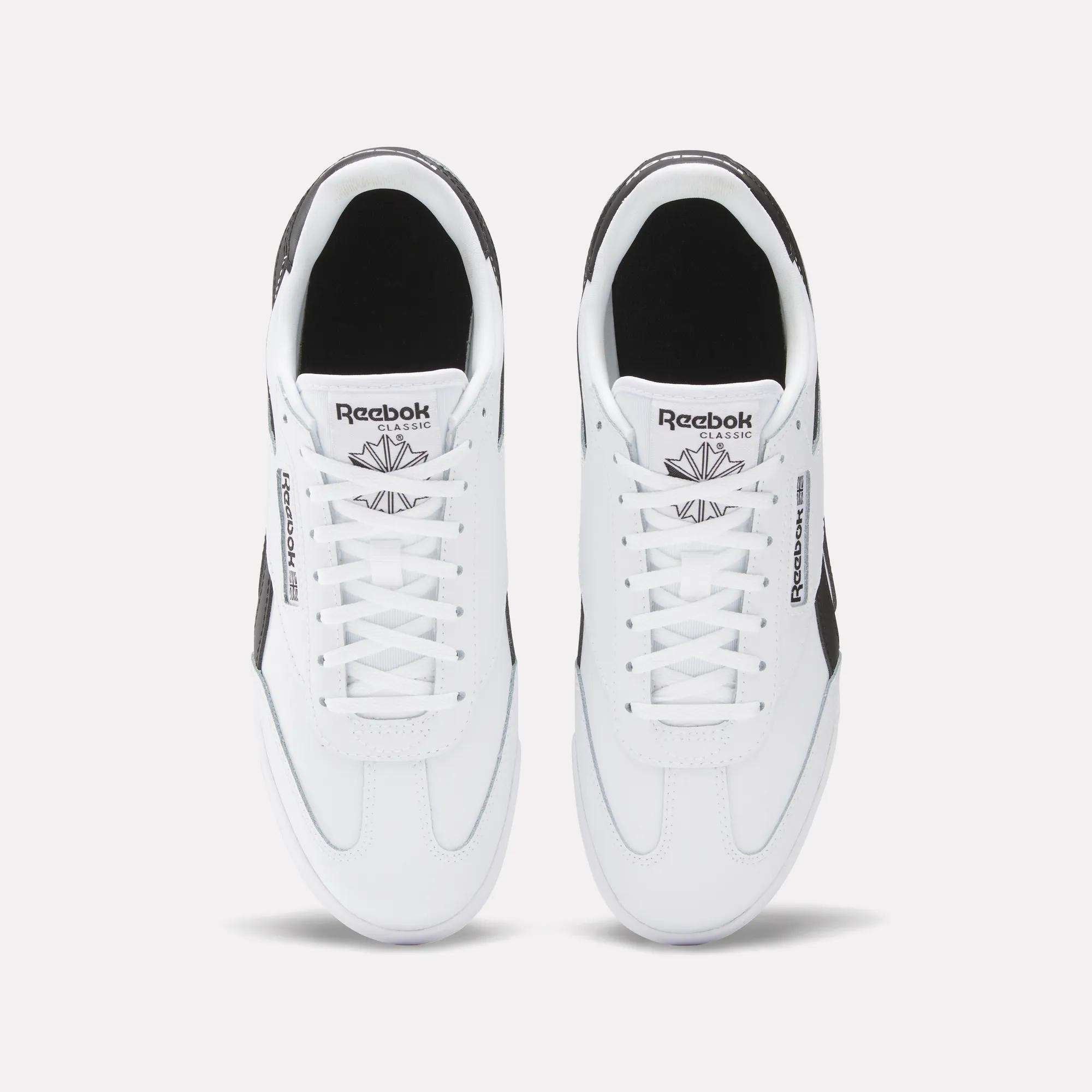 Top view of Reebok Campio XT Shoes in white with black accents and classic branding. These leather sneakers are side by side on a plain background, highlighting their timeless style.