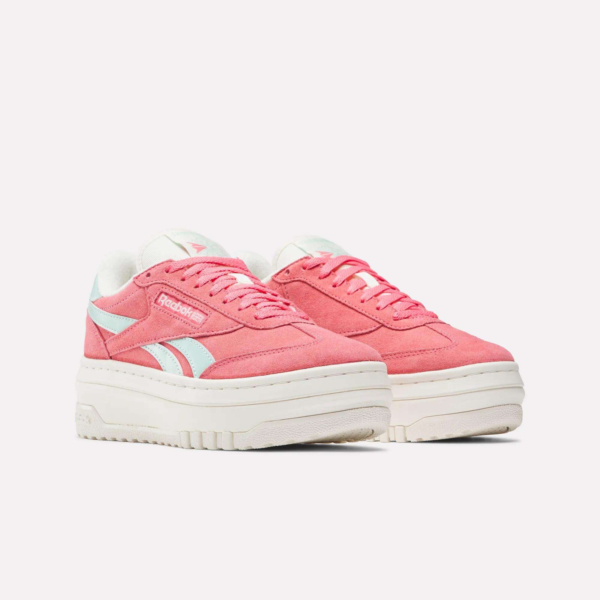 A pair of Reebok Campio Extra Women's Shoes in pink suede with a platform midsole, white thick soles, and light blue Reebok logos and accents, shown on a plain white background.