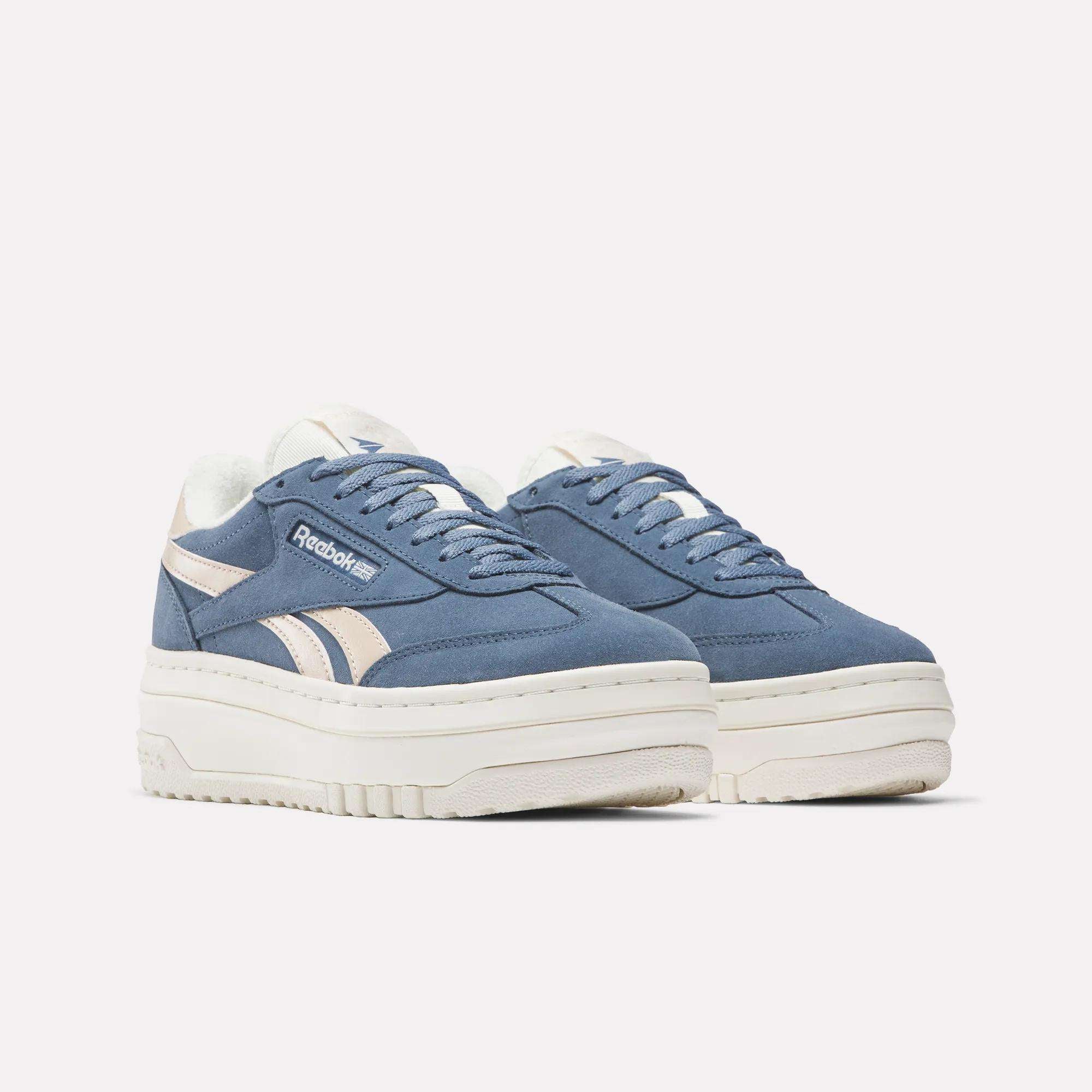 A pair of Campio Extra Women's Shoes by Reebok in blue and beige with thick white platform midsoles, shown on a plain white background.