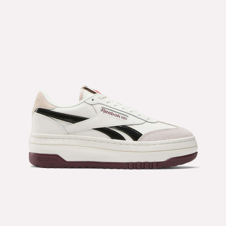 The Reebok Women's Campio Extra Shoes showcase a white leather upper with black stripes, maroon branding, beige suede accents, and a chunky maroon platform sole for a retro-inspired look.