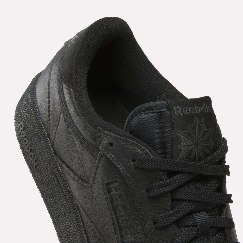 A close-up of the Reebok Men's Club C Golf Shoes in black, featuring water-resistant leather and a spikeless outsole.