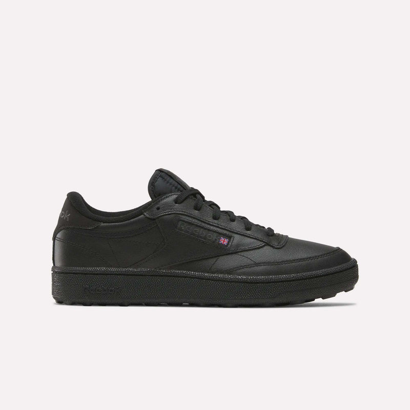 The Reebok Men's Club C Golf Shoes in black feature a low-top design, lace-up front, subtle side branding, spikeless outsole, and water-resistant leather, displayed against a plain white background.