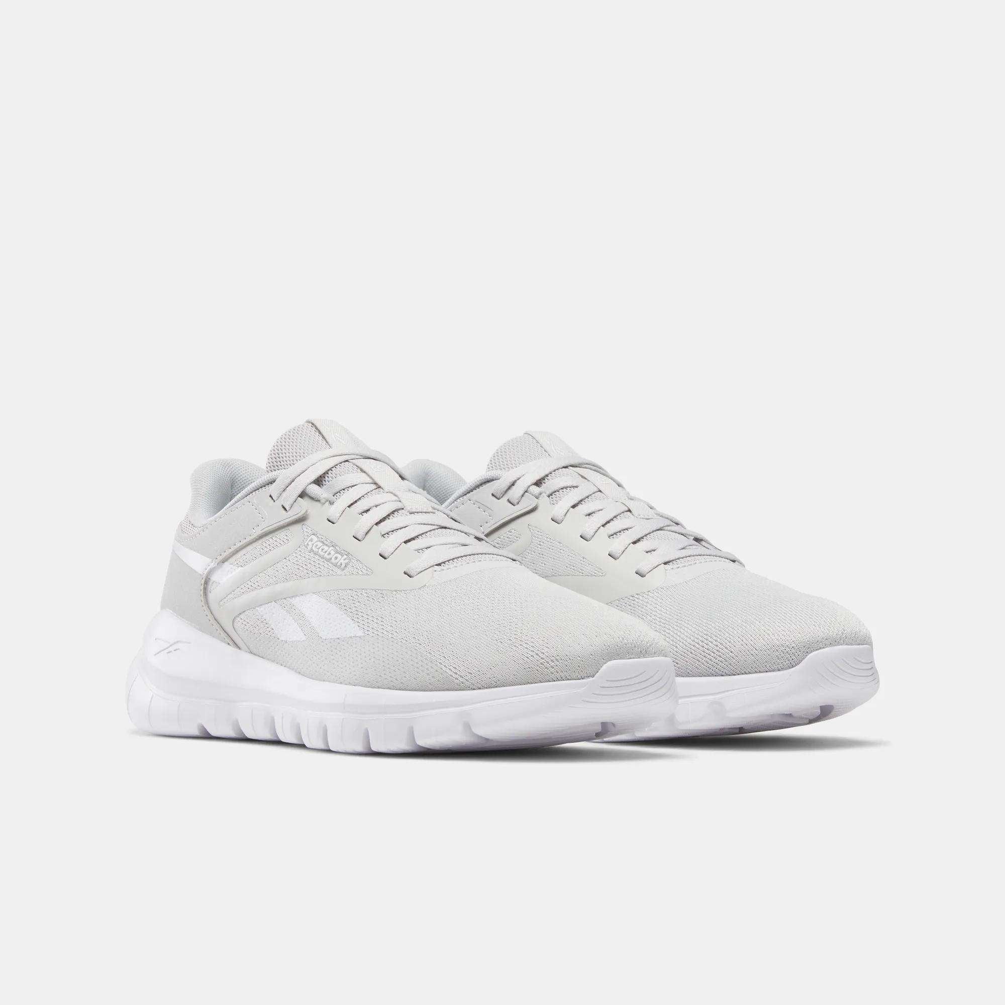 A pair of Reebok Men's Split Flex Training Shoes in light gray with white soles and subtle side branding, perfect for running, HIIT classes, or casual wear, shown on a plain white background.