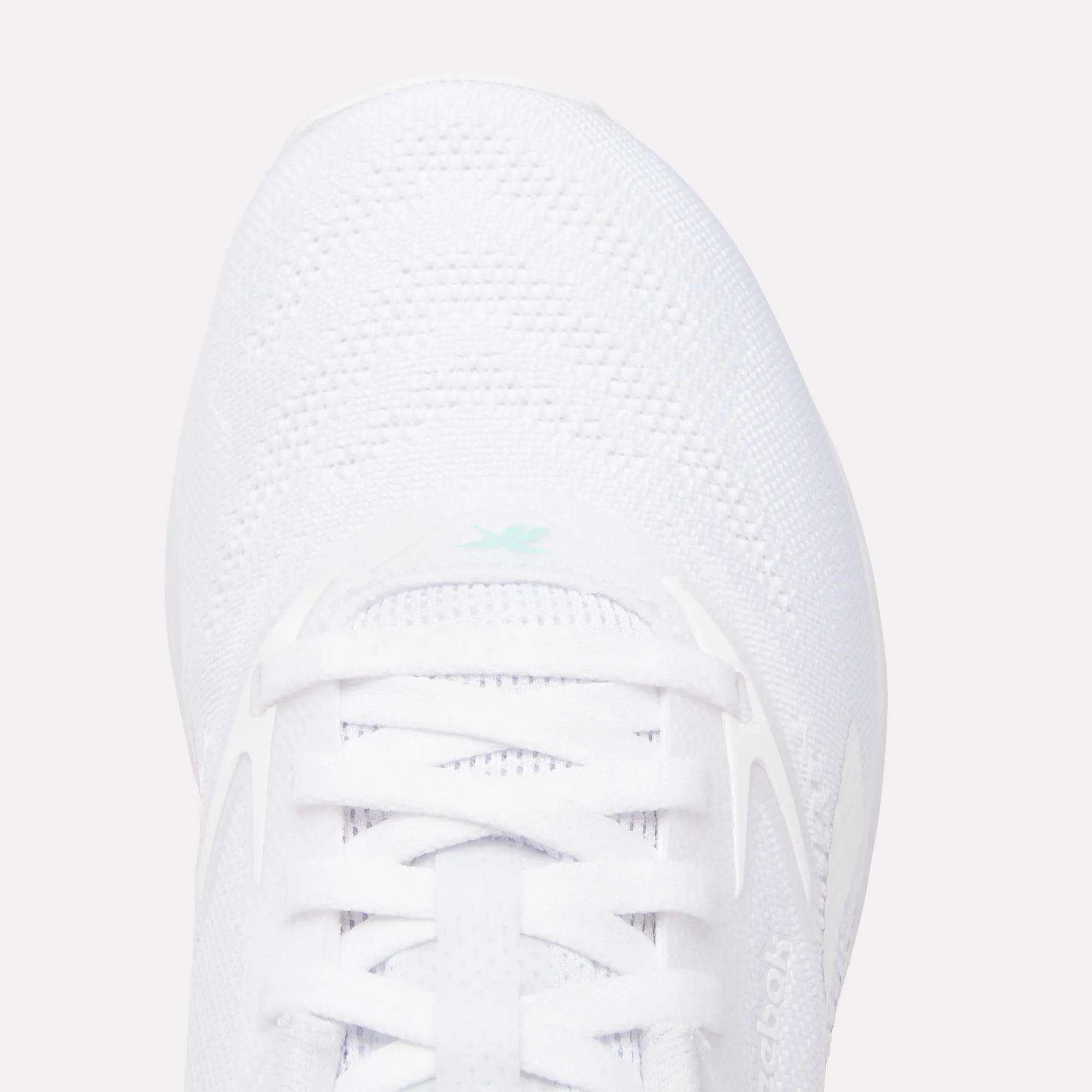 Top view of the Women's Nano X5 Training Shoes by Reebok, featuring comfortable white laces, breathable mesh texture, and a small light blue Reebok logo near the tongue.