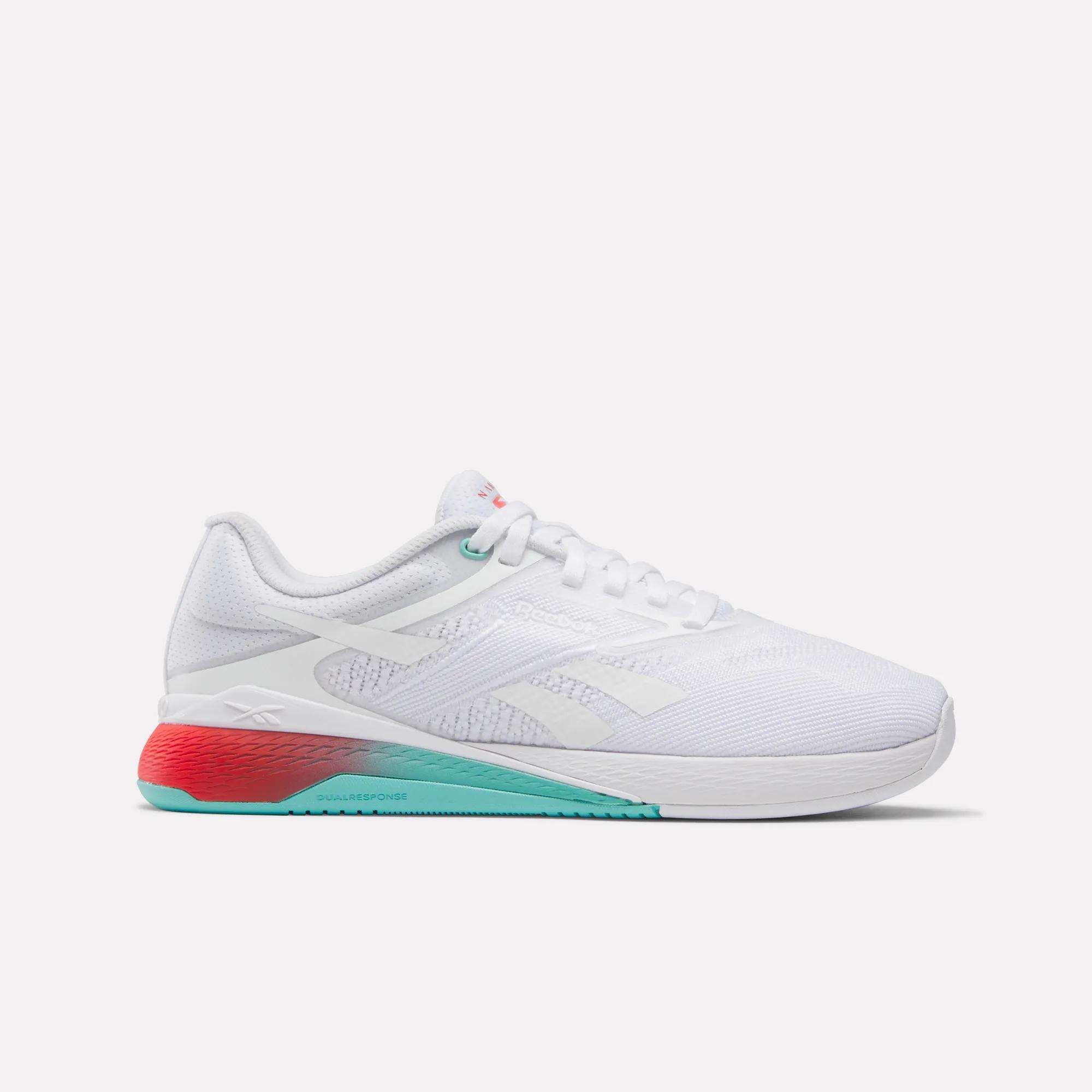 The Reebok Women's Nano X5 Training Shoes feature a white mesh upper, teal and red sole accents, white laces, and a low-top design—ideal for comfortable women's training—shown in side profile against a plain background.