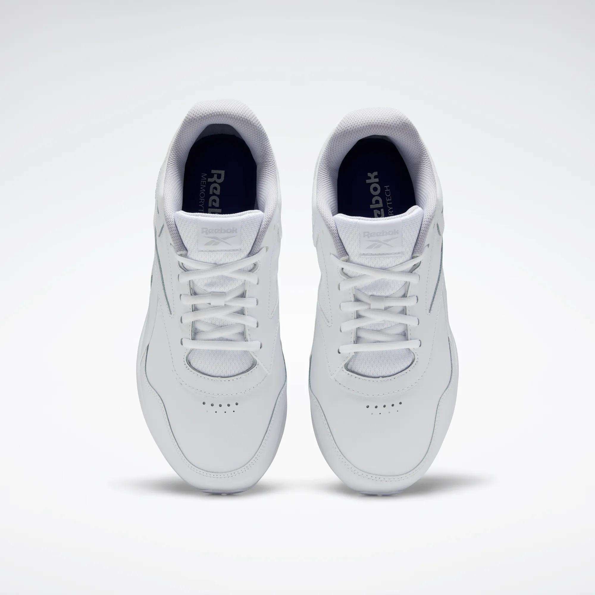 A pair of Reebok Women's Walk Ultra 7 DMX Max Walking Shoes in white, shown from above with visible tops and laces on a plain light background, featuring DMX cushioning for all-day comfort.