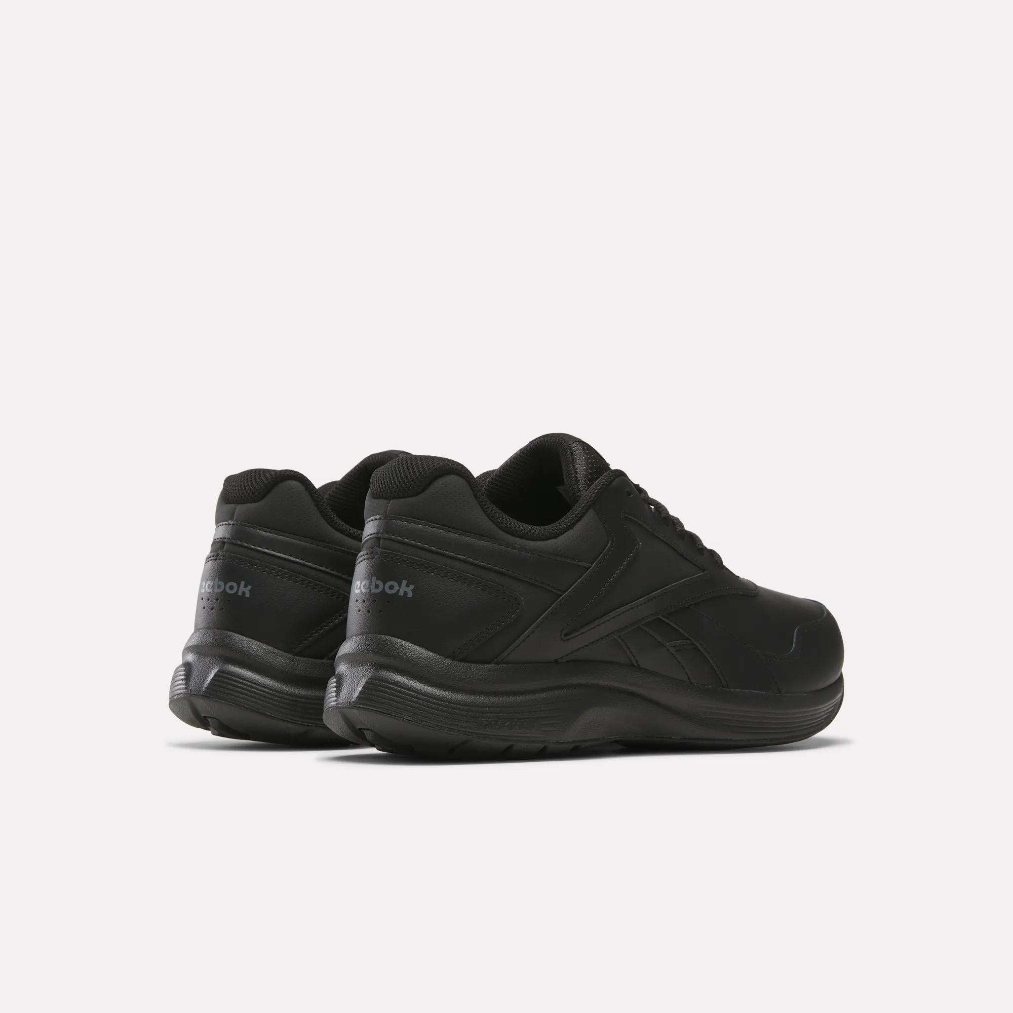 A pair of black Reebok Walk Ultra 7 DMX Max Walking Shoes with low tops and DMX cushioning, displayed from back and side views on a plain white background.