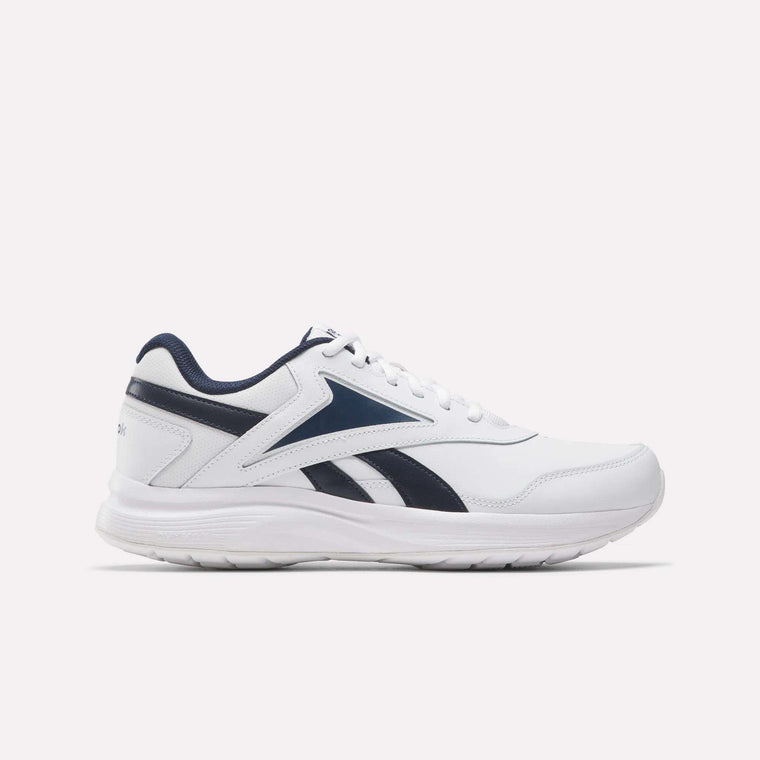 The Reebok Walk Ultra 7 DMX Max Walking Shoe in white with navy blue accents and the signature logo on the side features breathable mesh and cushioned support, shown from the left against a plain white background.