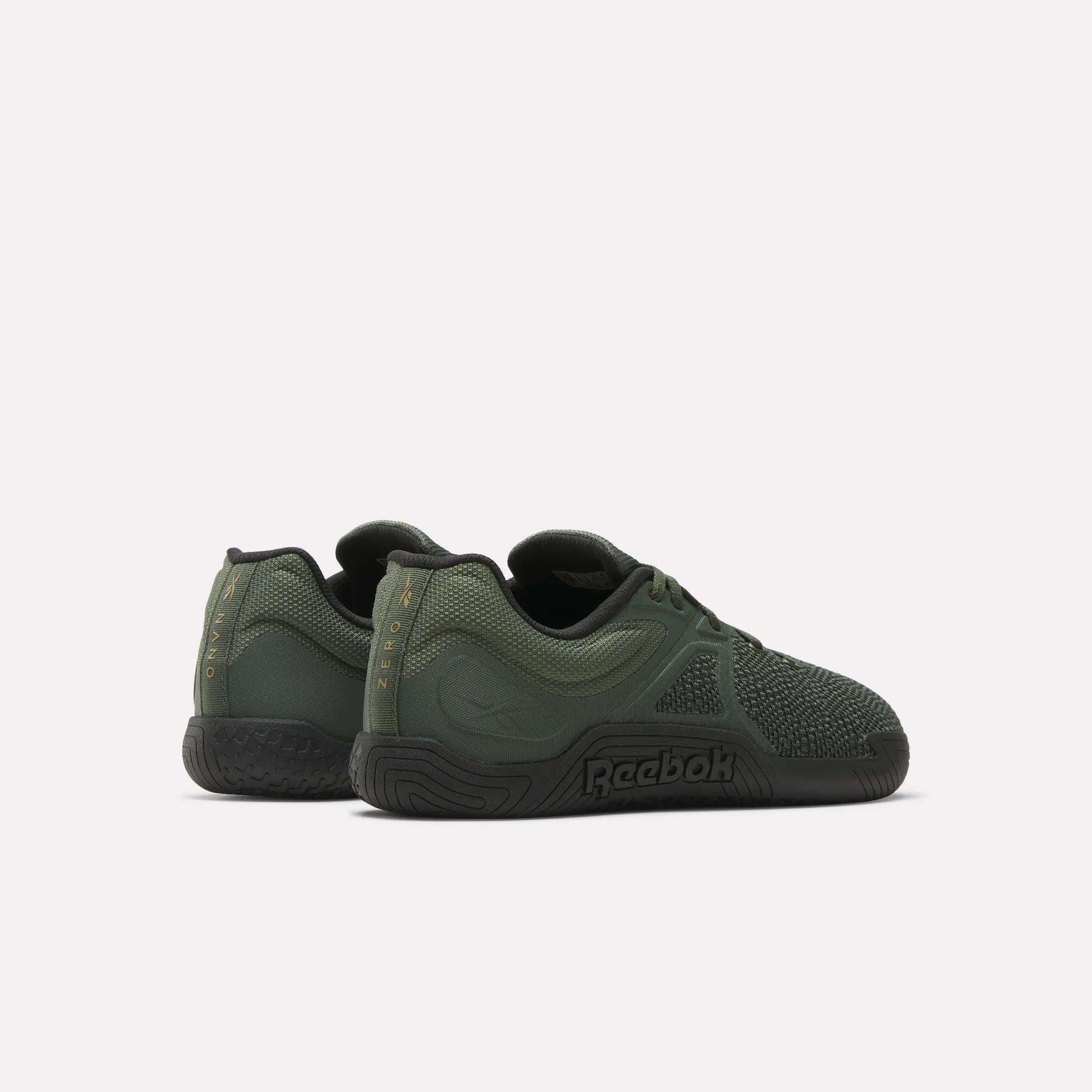 A pair of Reebok Nano Zero Training Shoes in dark green with textured accents and black soles, shown from the back and side on a plain light background.