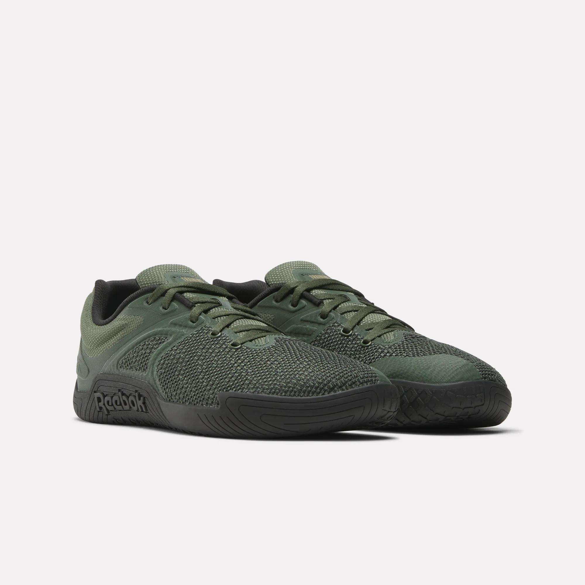 The Reebok Nano Zero Training Shoes in olive green, with black soles and laces, feature textured mesh uppers and a side Reebok logo—perfect for strength training.