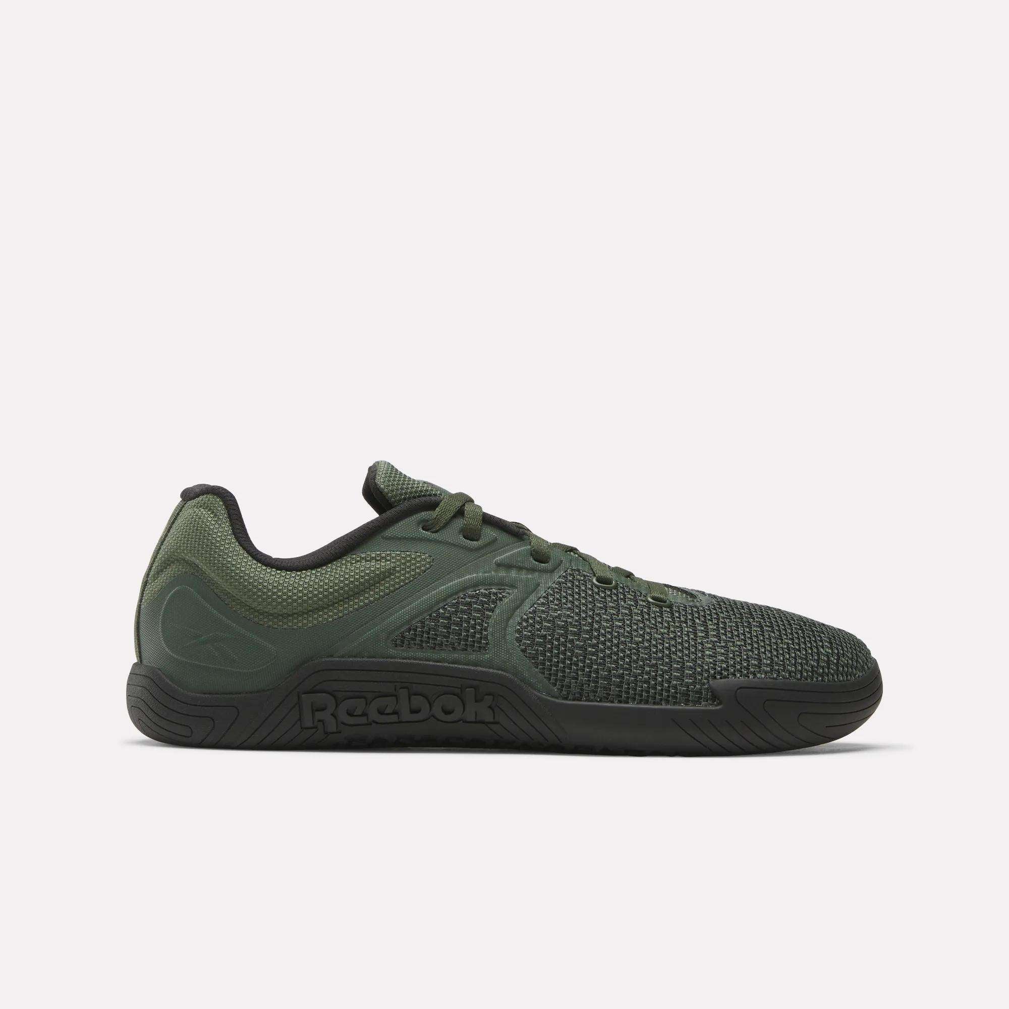 A side view of the Reebok Nano Zero Training Shoes in green, showcasing a textured mesh upper, supportive overlays, and a black sole with an embossed Reebok logo. Perfect for strength training.