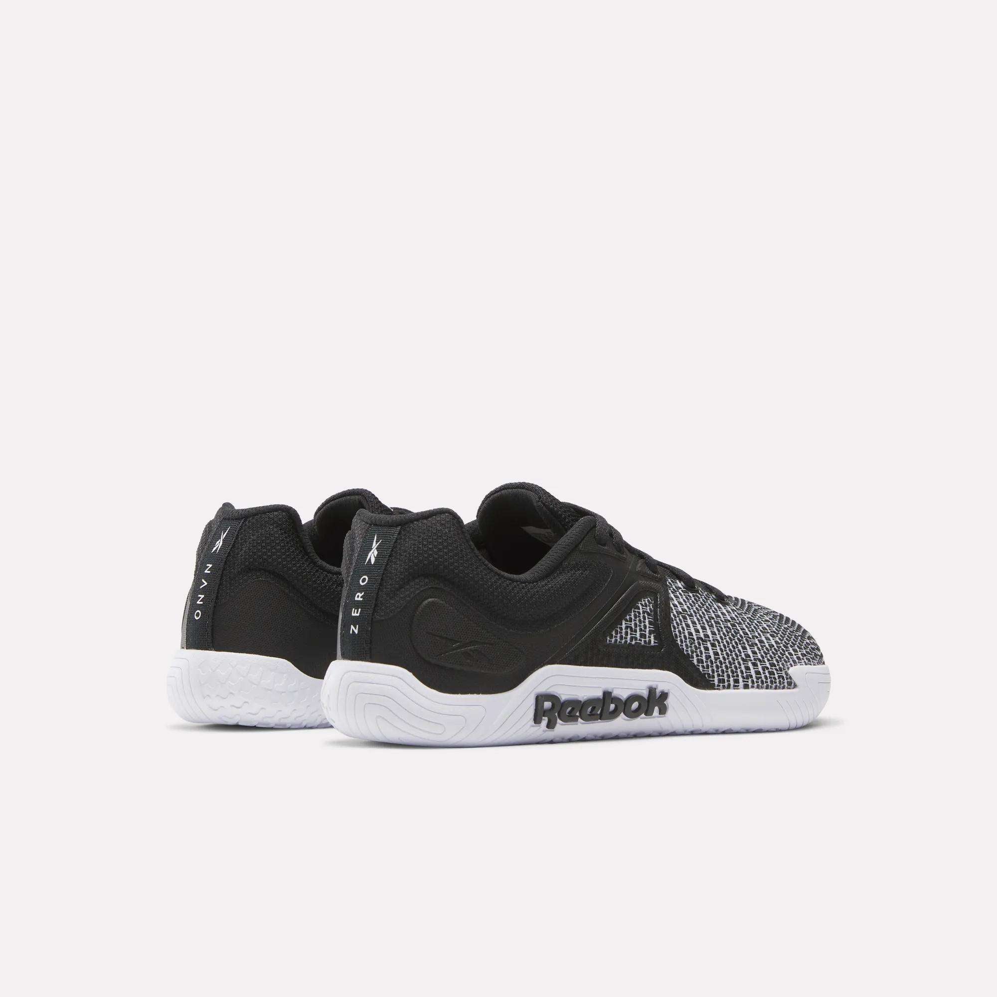 Reebok Women's Nano Zero Training Shoes in black and white feature a textured front, logo on the sole, and "Zero" and "Onyx" on the heel—ideal for strength training—shown against a light background.