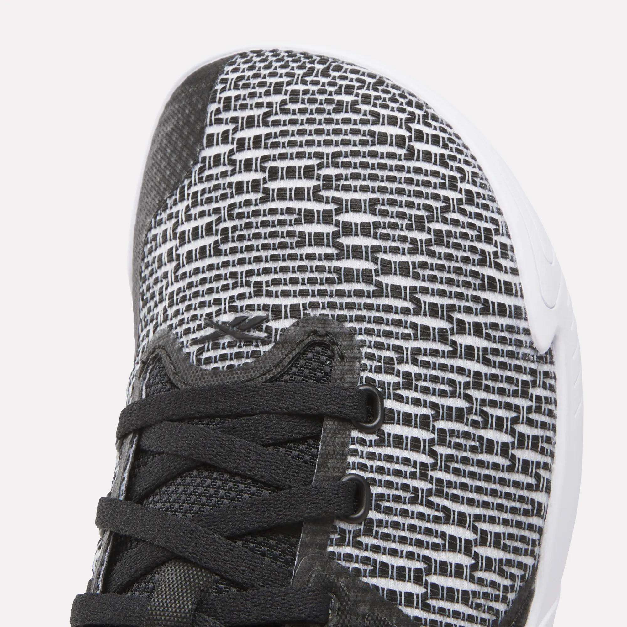 Close-up of the Reebok Women's Nano Zero Training Shoe’s toe, showcasing a black and white woven upper, black laces, and a white textured sole—perfect for strength training.