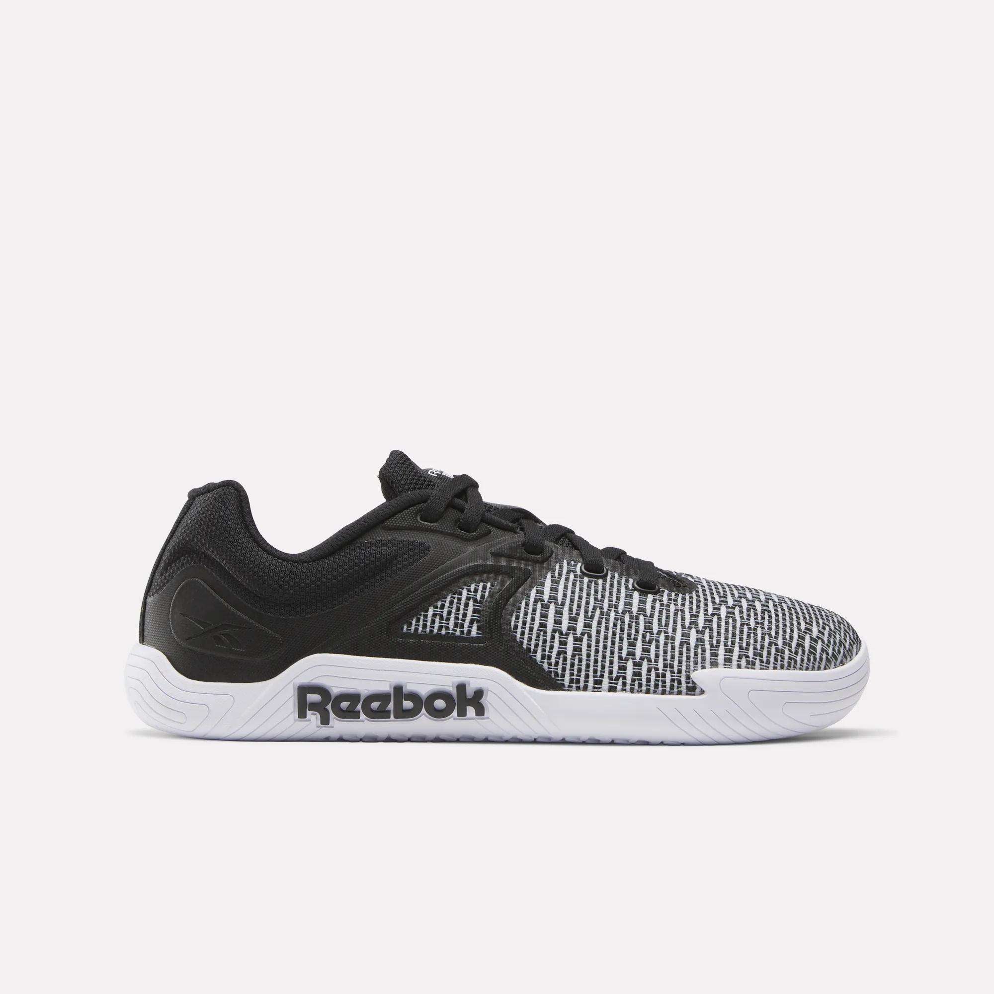The Reebok Women's Nano Zero Training Shoes feature a black and white design with a textured pattern, black laces, white sole, and side Reebok logo—ideal for strength training. Set against a plain, light background.