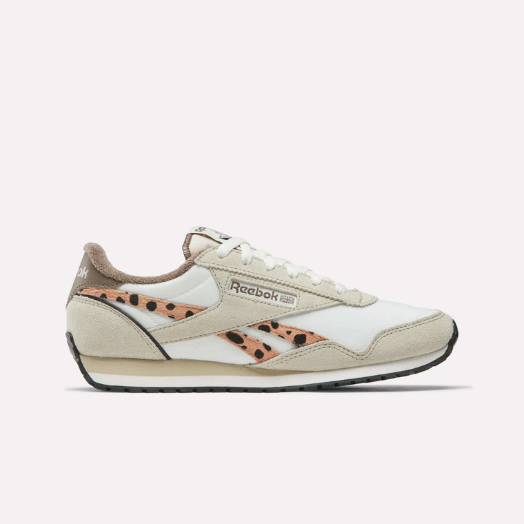 The Reebok Women's Classic AZ Shoes feature a white and beige design with tan and black polka-dot details, beige suede accents, and a black rubber sole—shown side view on white for an authentic retro style.