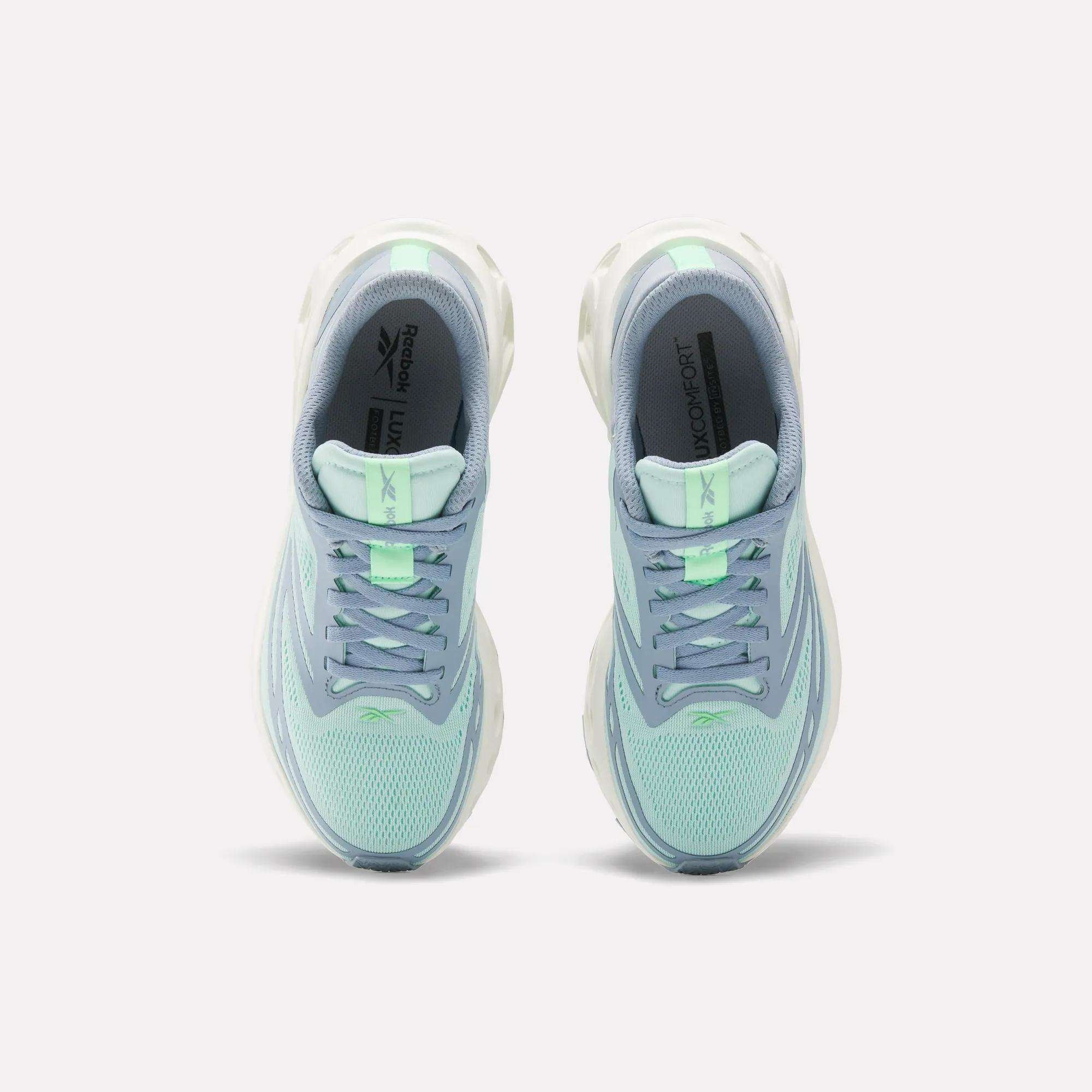 A pair of Women's Fuel Flex Run Shoes by Reebok in light blue and mint green are shown side by side from above, highlighting the laces, mesh uppers, branded insoles, and Fuel Flex midsole for lasting comfort.