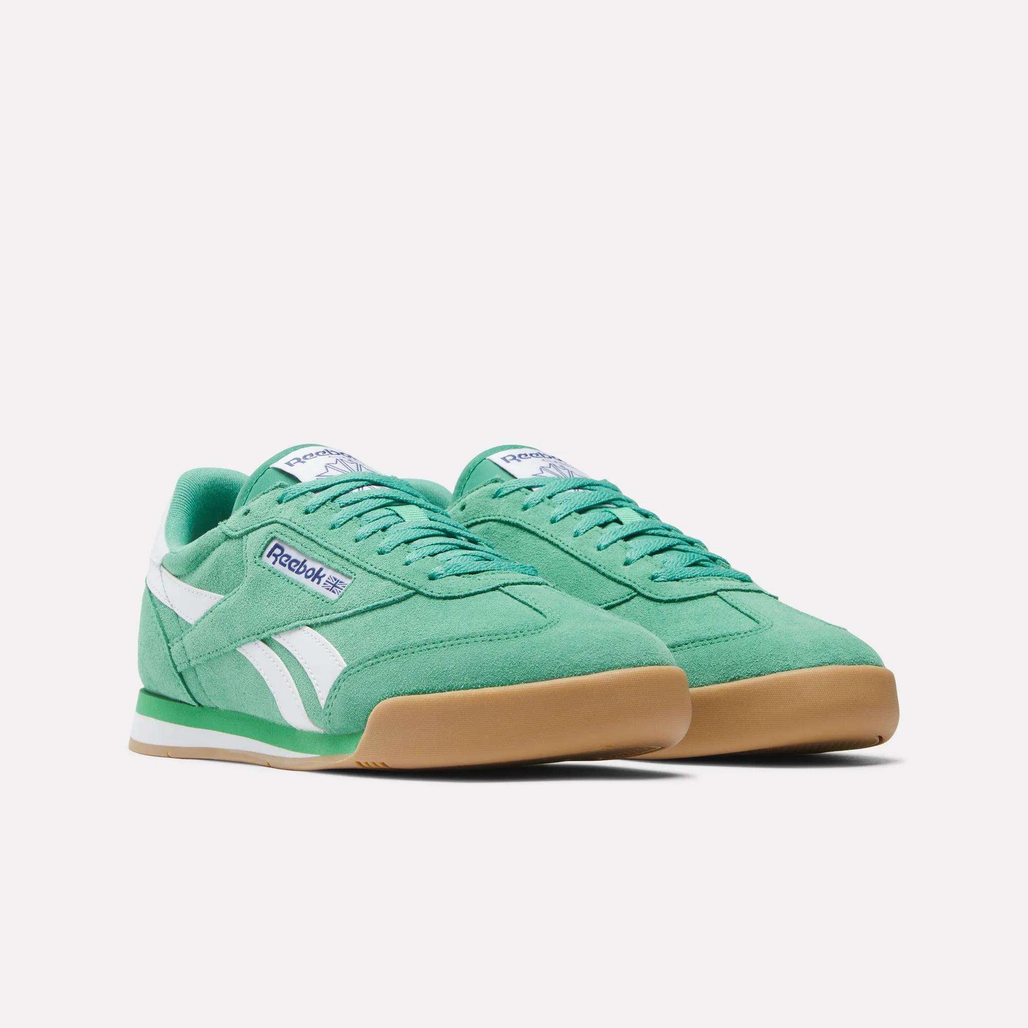 A pair of green Reebok Campio XT Shoes with white accents, gum soles, and purple branding evoke '90s soccer style against a plain white background.