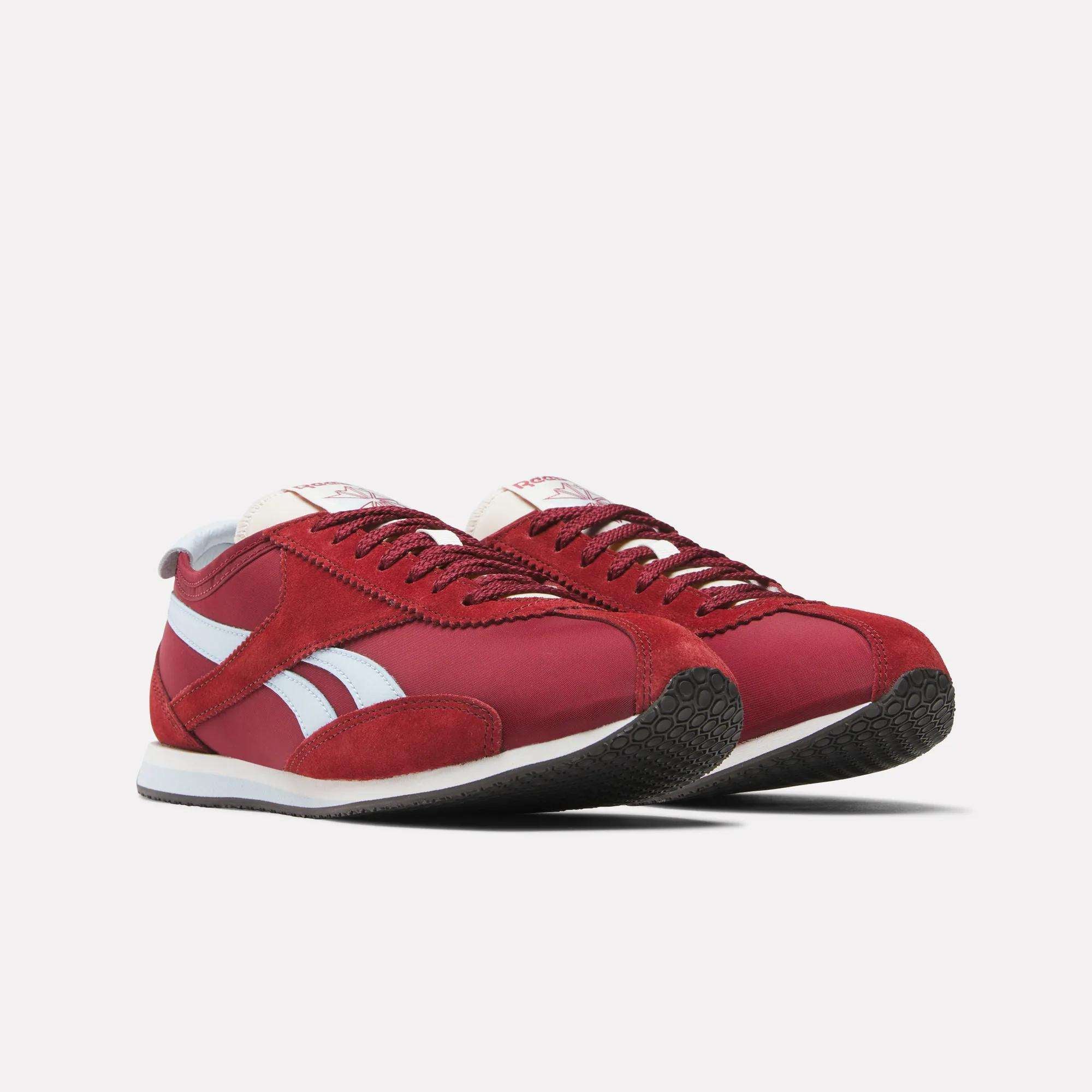 The Reebok R400 Shoes feature a red retro design with white side stripes, white soles, and black textured outsoles, shown on a light background.