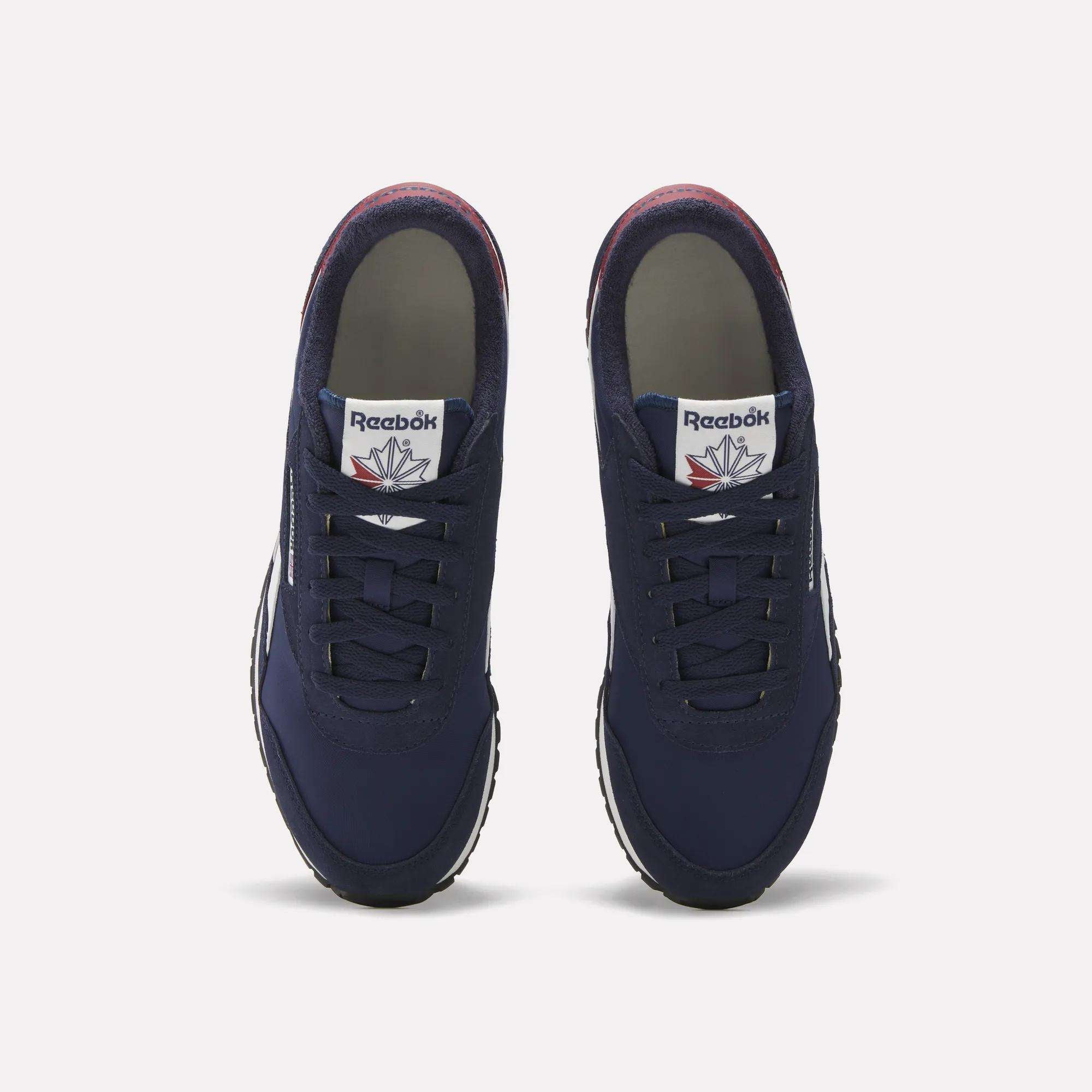 A pair of Reebok Classic AZ Shoes in navy blue, shown from above with laces, white tongue tags bearing the Reebok logo, and white rubber soles on a plain background—evoking classic retro running style.