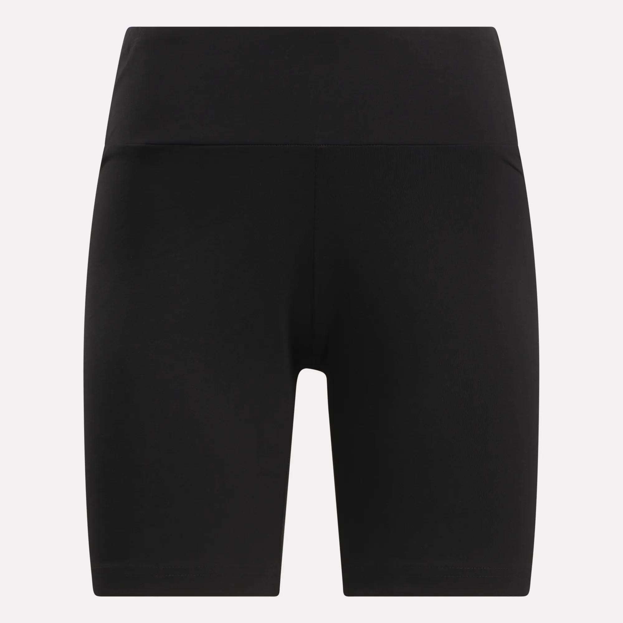 Women's Small Logo Cycle Shorts by Reebok: black, high-waisted cotton cycle shorts with a wide waistband. Knee-length with a stretchy, seamless fit, shown on a plain light background.