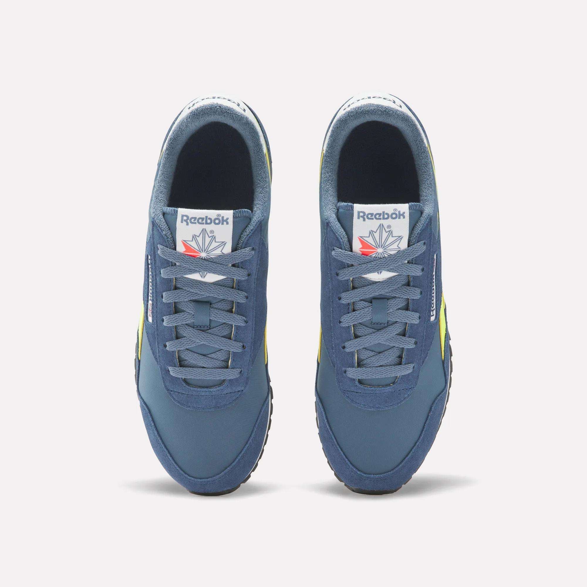 Top view of Reebok Classic AZ Shoes in blue with gray laces, white tongues featuring the Reebok logo and red star, and yellow side accents, capturing '70s retro running style, displayed on a white background.