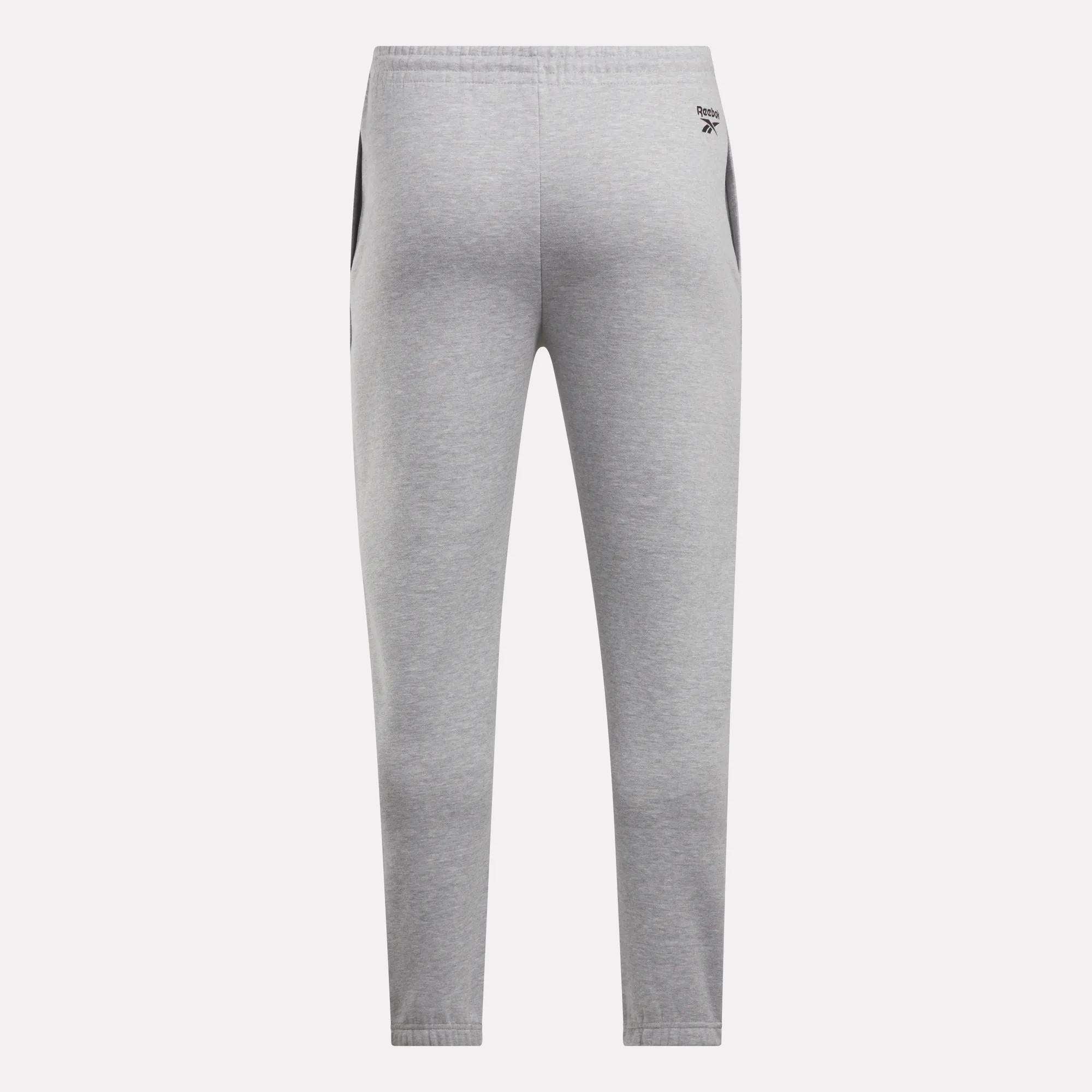 Back view of Reebok Men's Joggers in light gray with black side panels, elastic waistband, and a small logo on the left hip, shown against a plain white background.