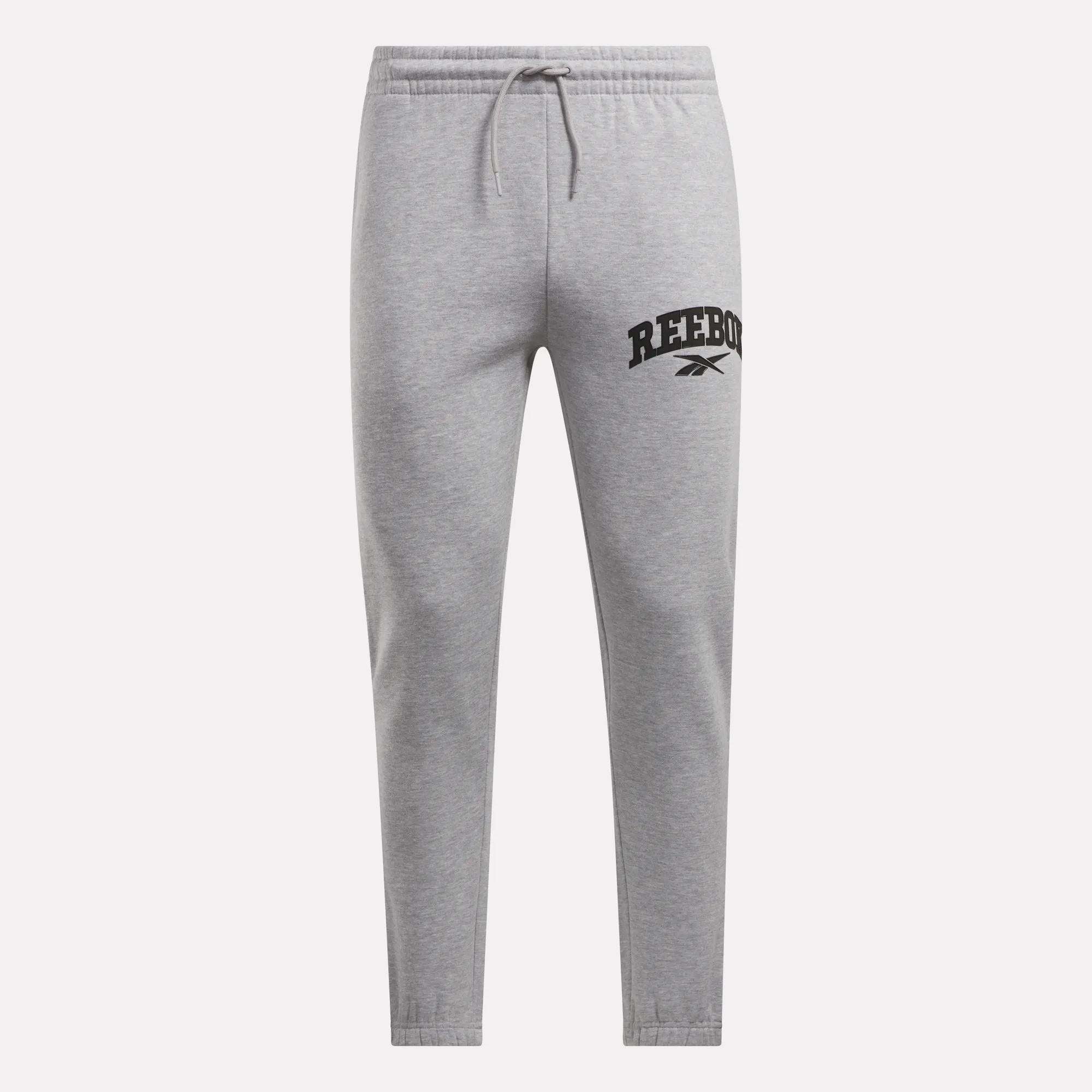 Reebok Men's Joggers in light gray, crafted from soft fleece with an elastic waistband, drawstring, and tapered legs. The left thigh features a black Reebok logo and vector symbol. Shown on a plain white background.