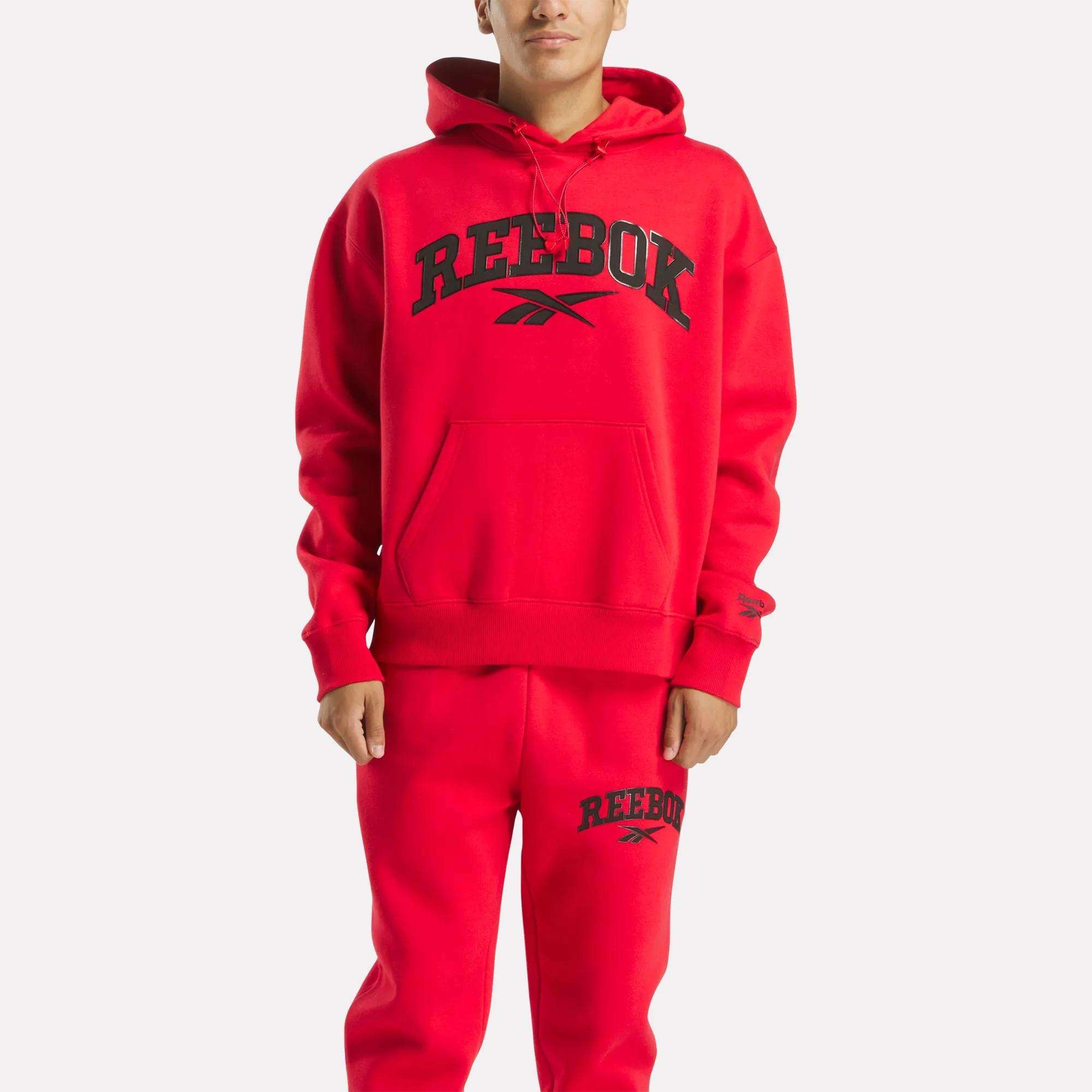 A man wearing a Reebok Men's Hoodie and matching pants.